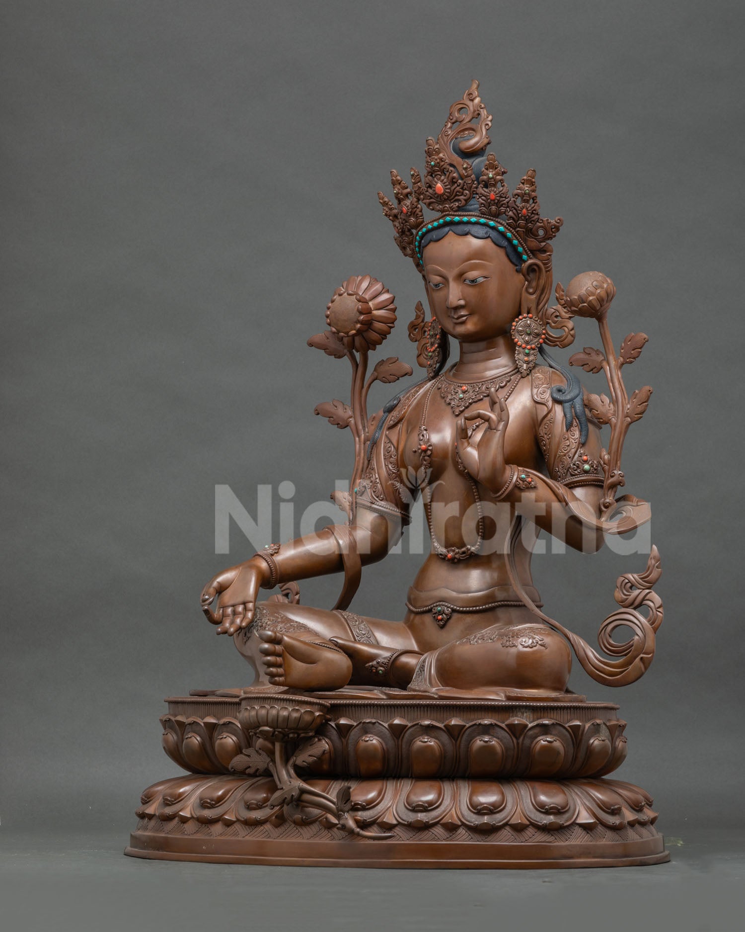 Left side view of large oxidized copper Green Tara statue on double lotus pedestal