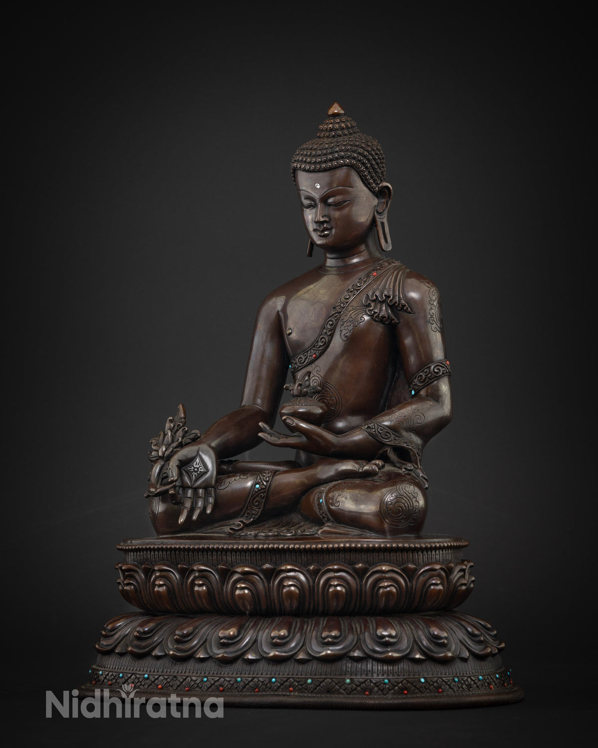 Left side view of Medicine Buddha statue holding healing bowl, oxidized copper altar sculpture