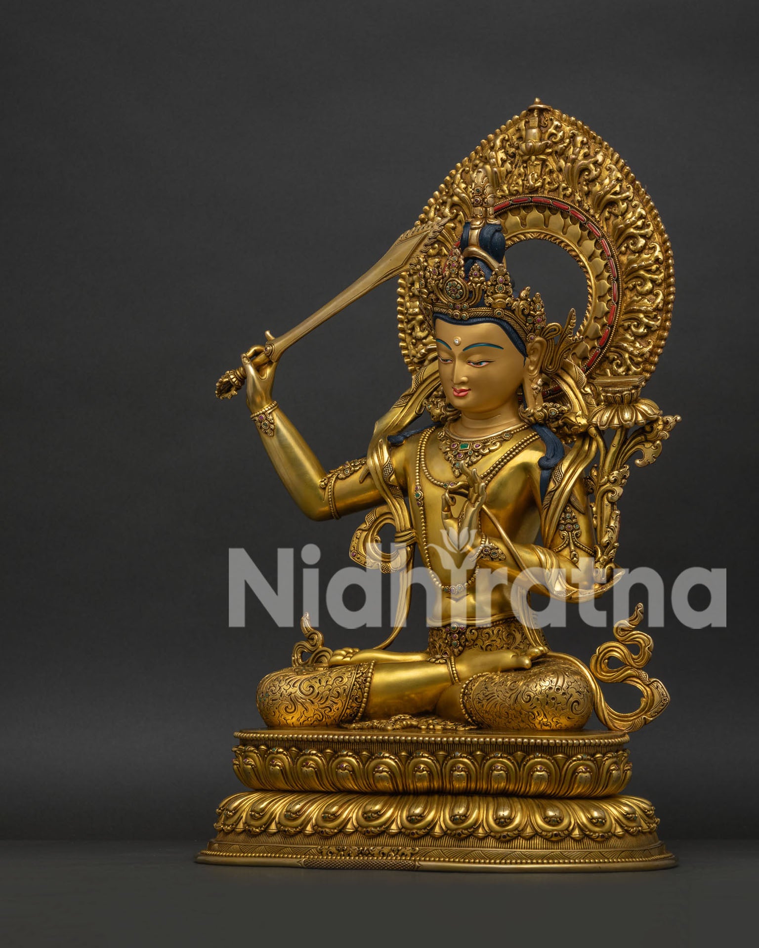 Left side view of Nepalese Manjushri Statue with Sword of Wisdom and lotus