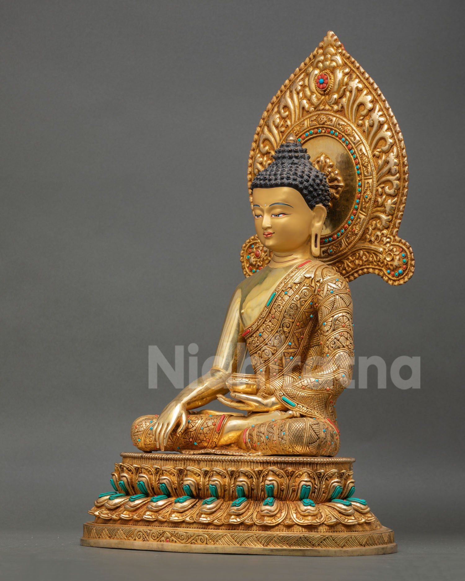 left side view of shakyamuni buddha sculpture with lotus base and sacred bowl
