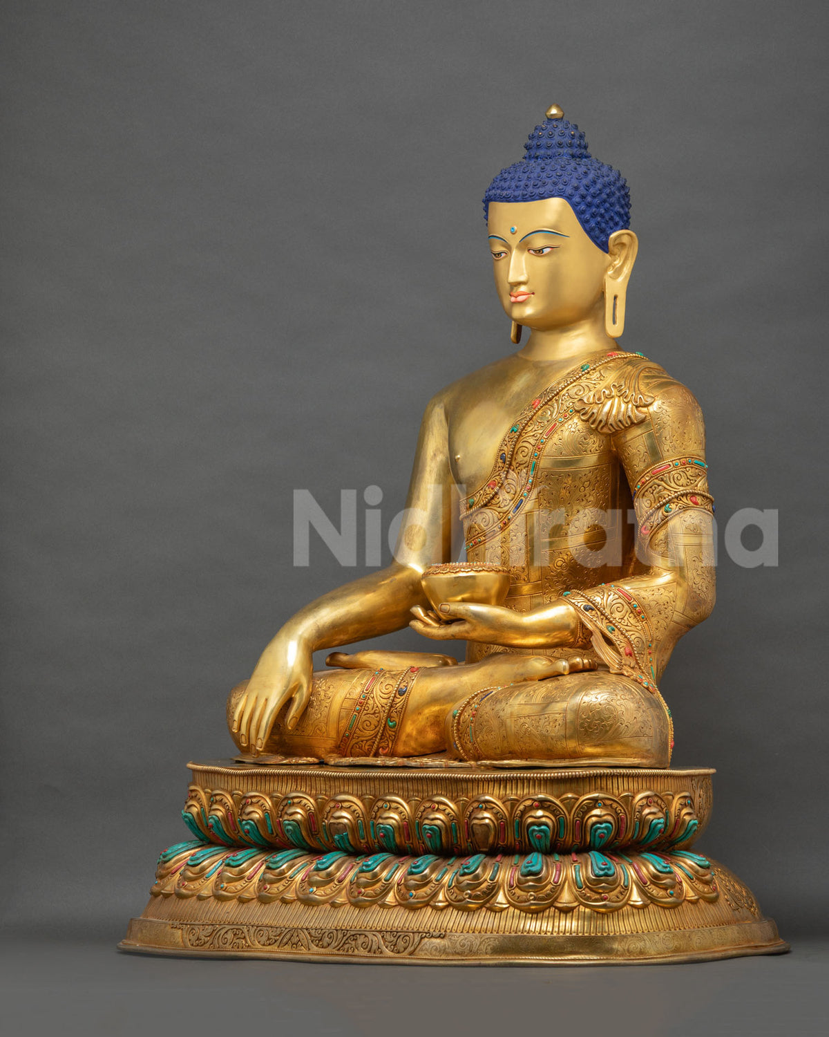 Left side view of Shakyamuni Buddha statue holding monk's bowl on gold lotus throne