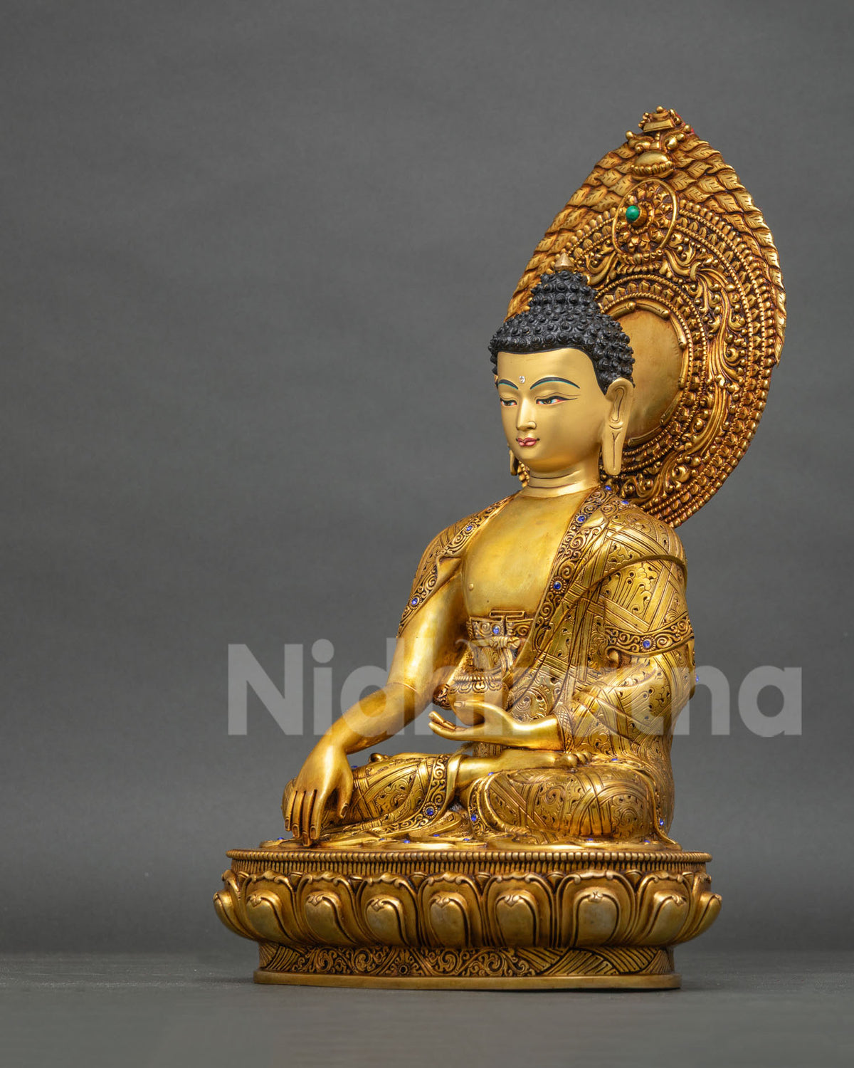 Left side view of Shakyamuni Buddha statue holding the Patra bowl, gold-gilded copper from Nepal