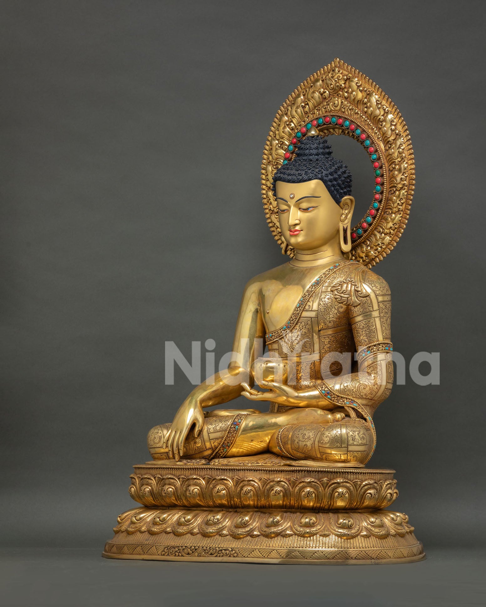 left side view of shakyamuni buddha statue on lotus throne with jeweled halo