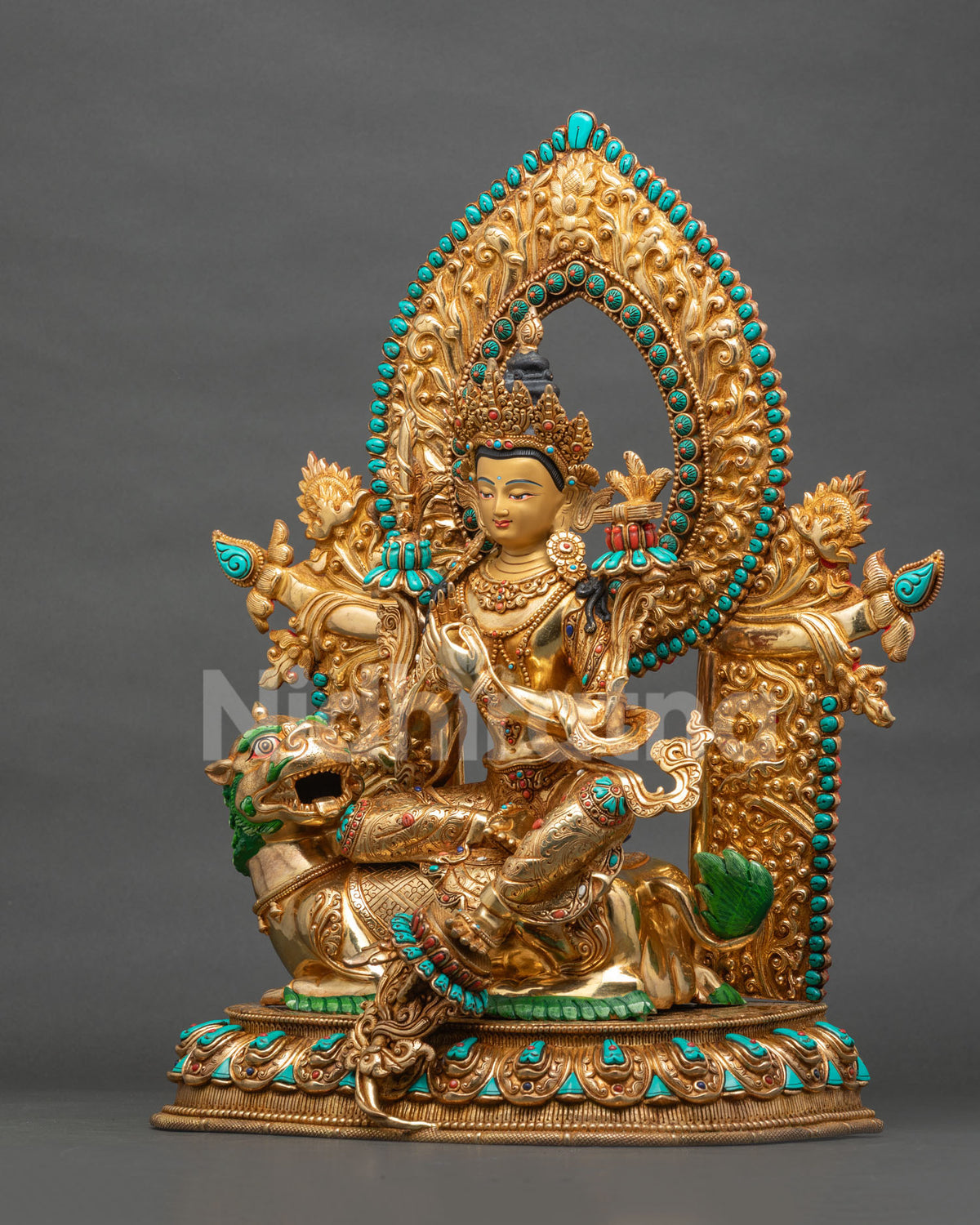 Left side view of Simhanada Manjushri statue with gemstone-embellished halo, Nepalese Buddhist art
