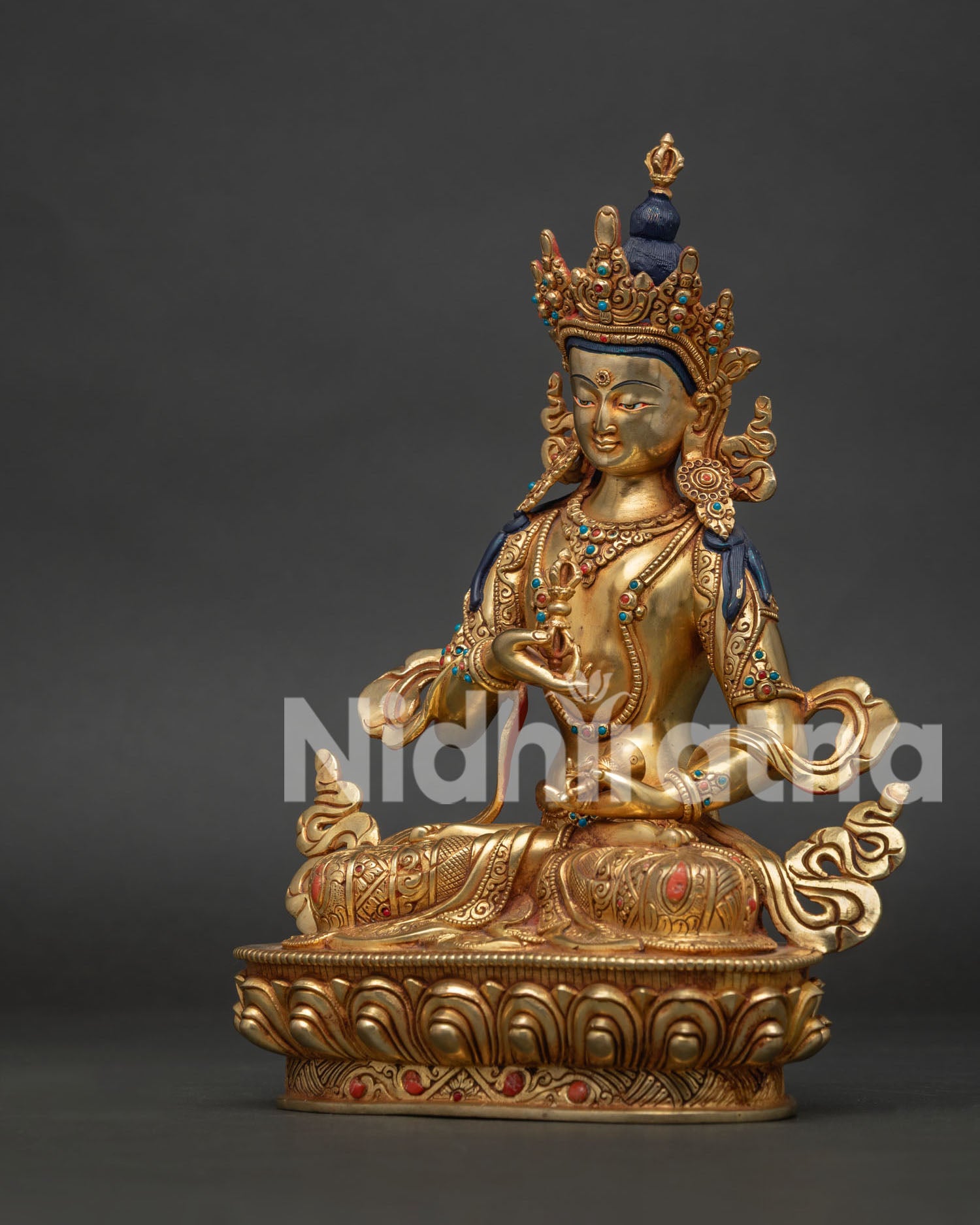 Left side view of the gold gilded Vajrasattva Buddhist statue crafted using the ancient lost wax method.