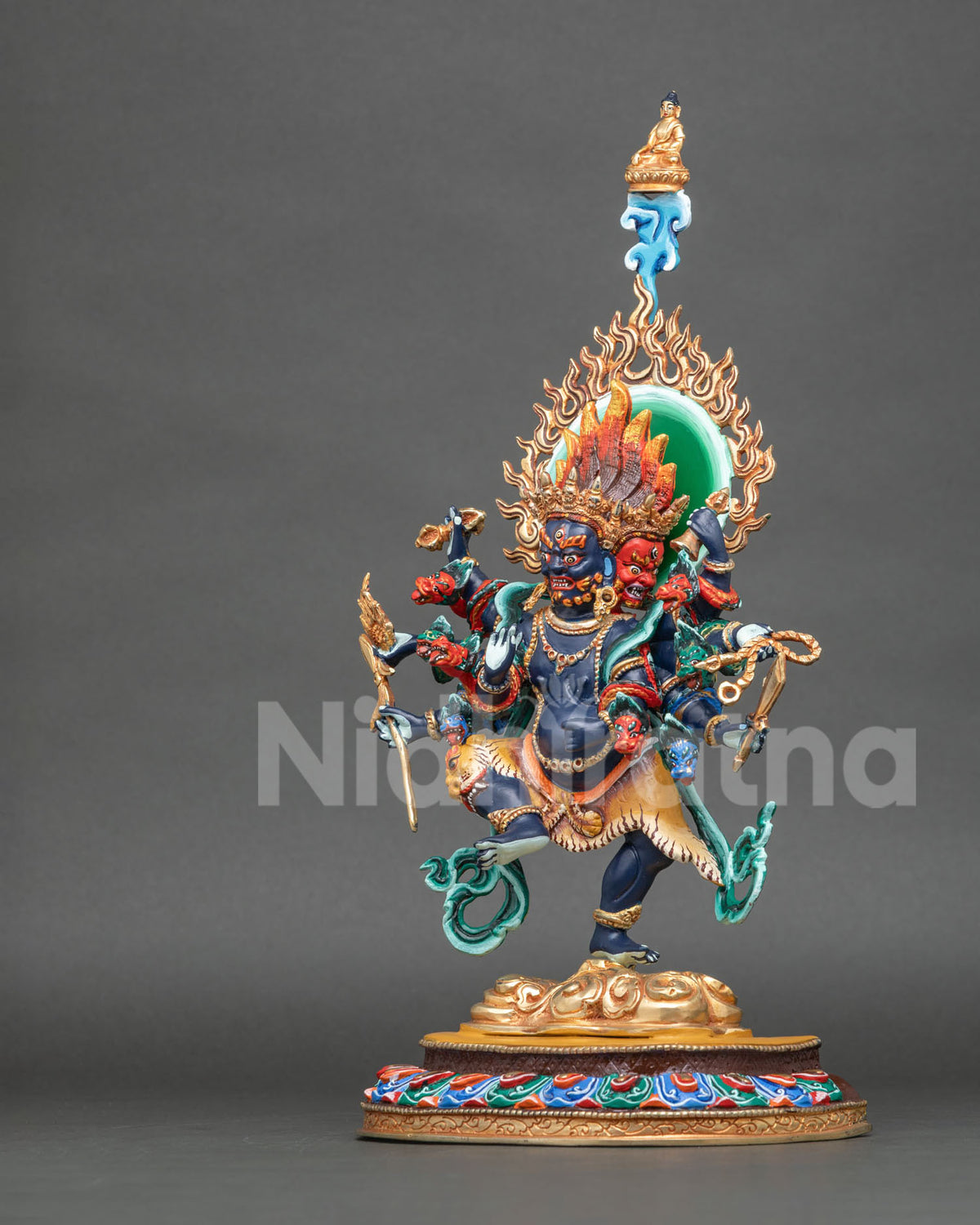 Left side view of Ucchusma statue standing on a multi-colored lotus pedestal from Nepal