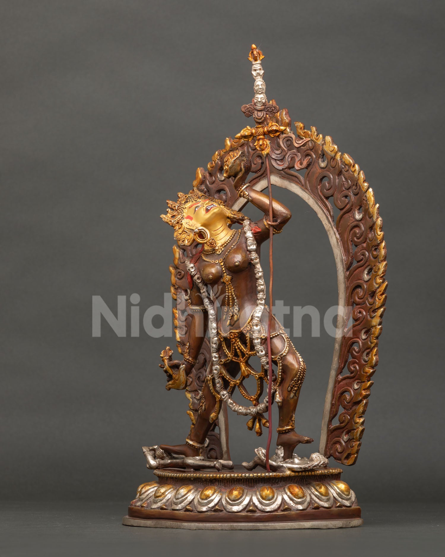 Left side view of Vajrayogini statue showing skull cup and khatvanga staff
