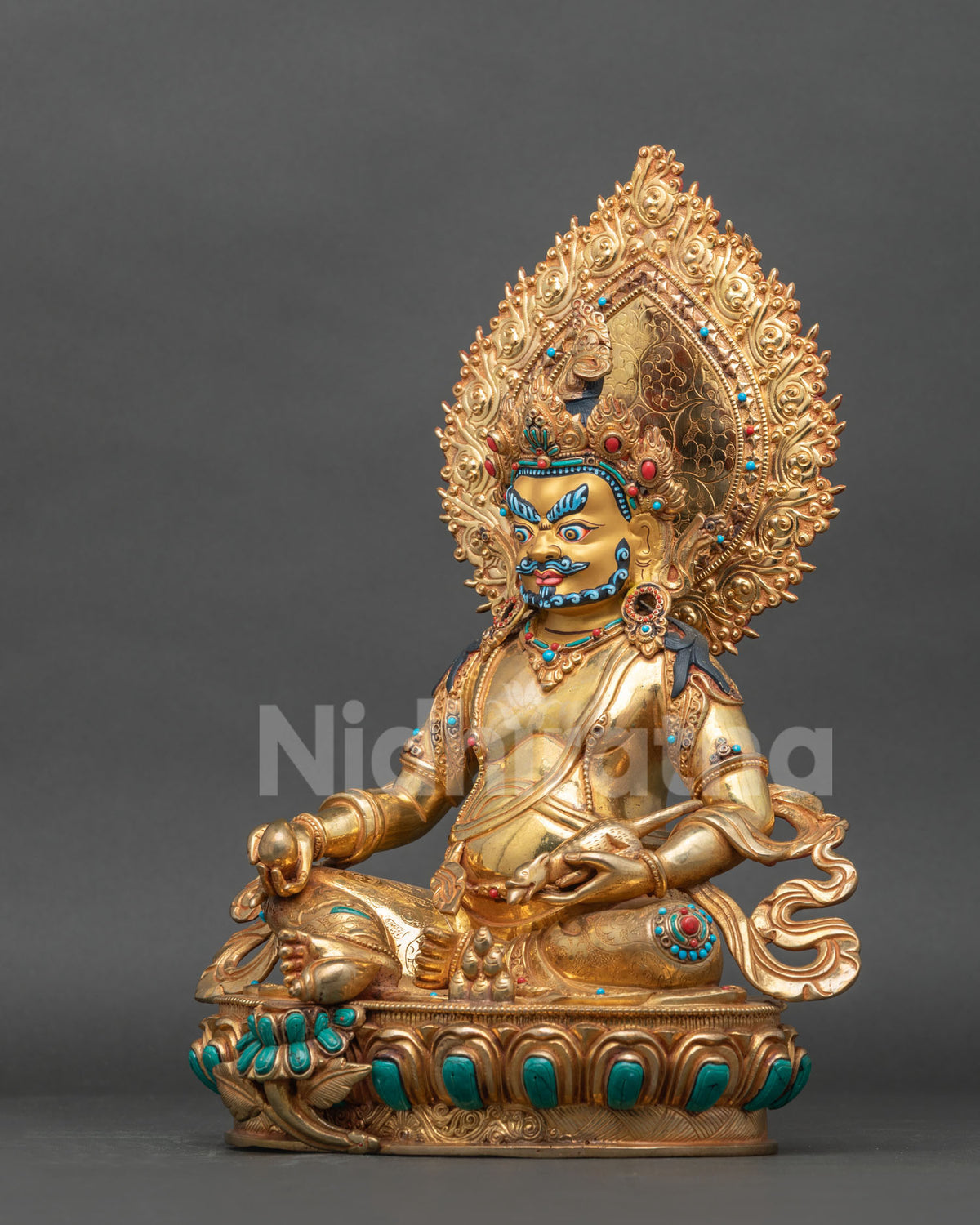 Left side view of Wealth God Dzambhala statue with gold fire-gilded halo and mongoose