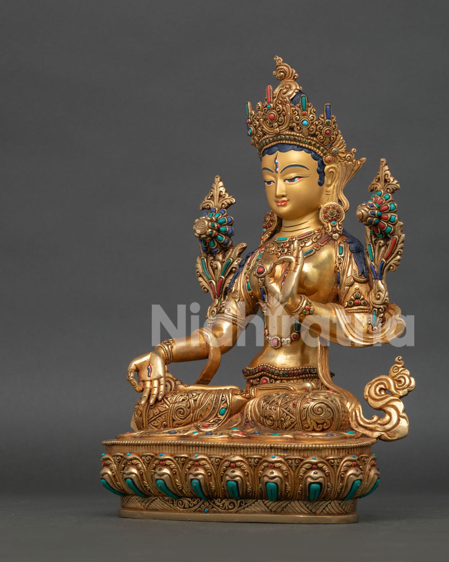 left side view of white tara drolma karmo sculpture with copper and gold finish