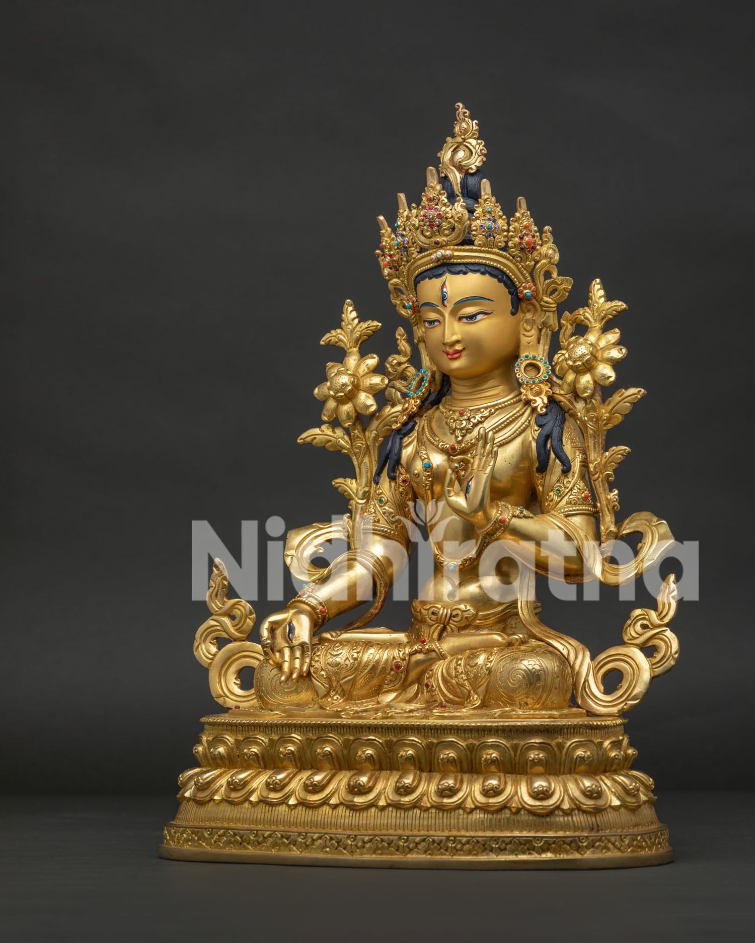 Left side view of White Tara Statue with jeweled crown and flowing robes
