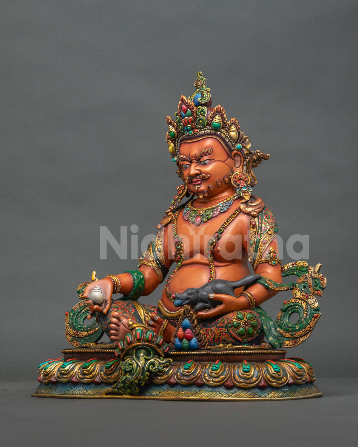 Left side view of Yellow Dzambhala copper statue cradling a jewel-spouting mongoose on a lotus base