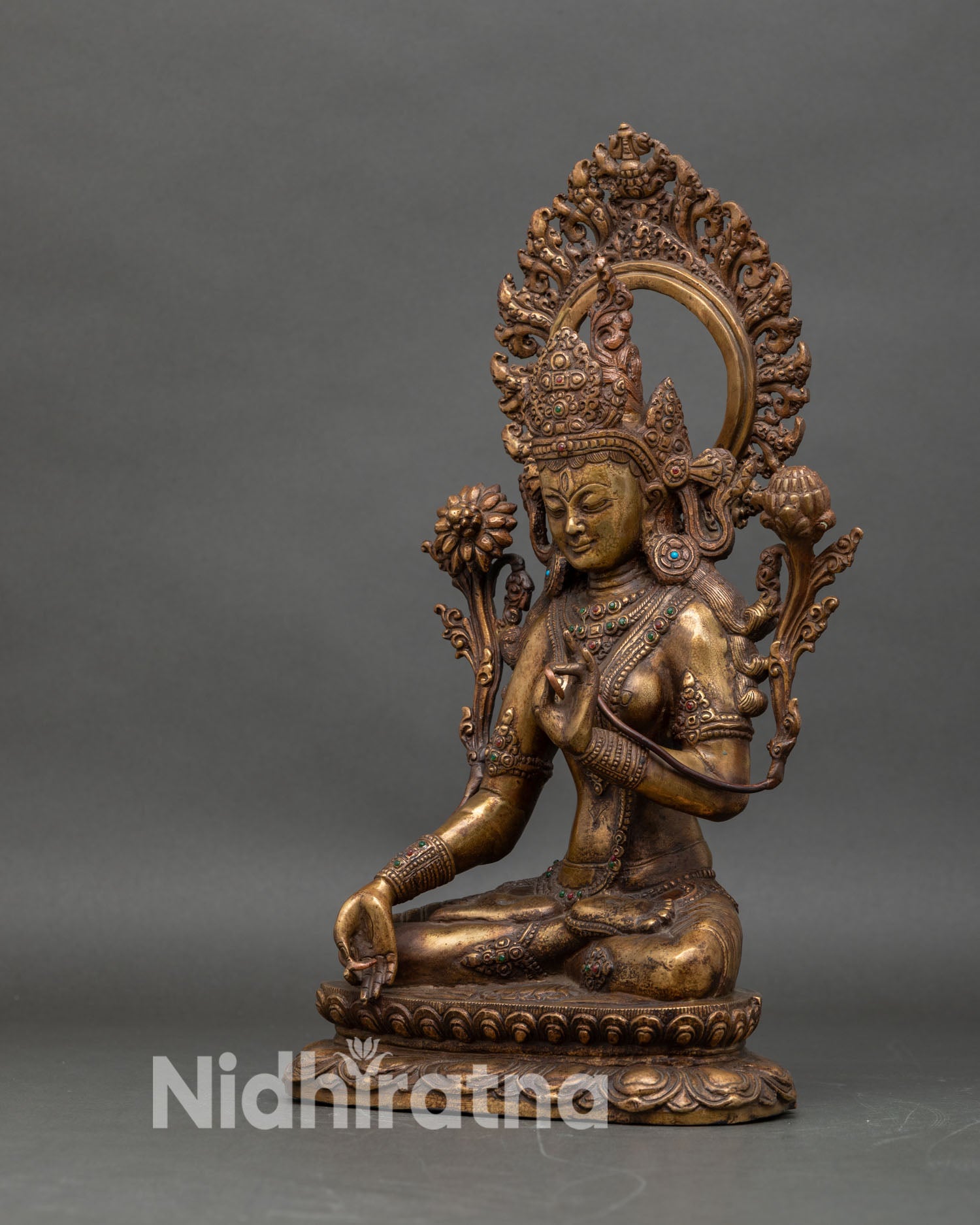 Left side view of vintage White Tara statue showing detailed jewelry and lotus posture