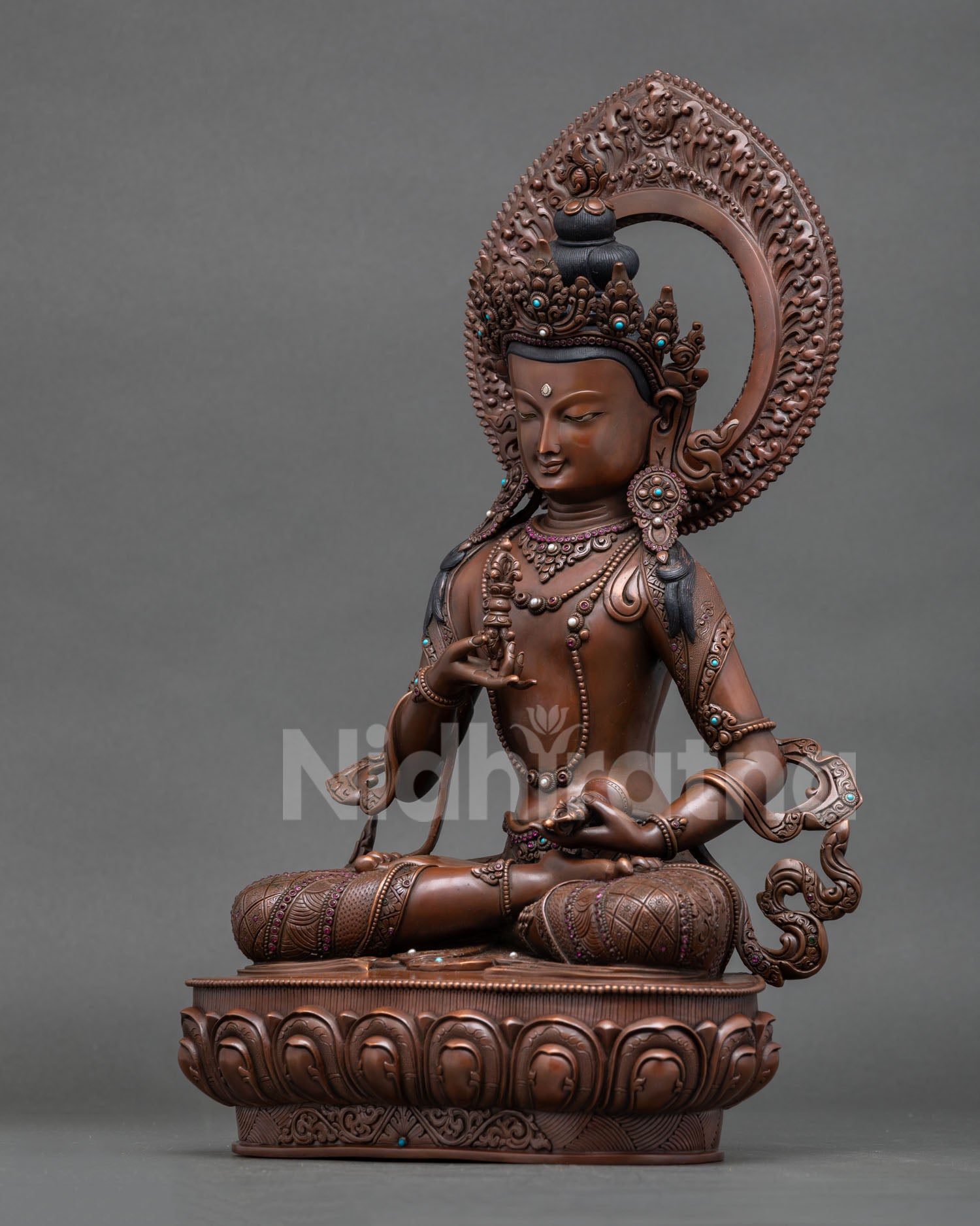 Left view of black Vajrasattva sculpture with flowing robes and halo details