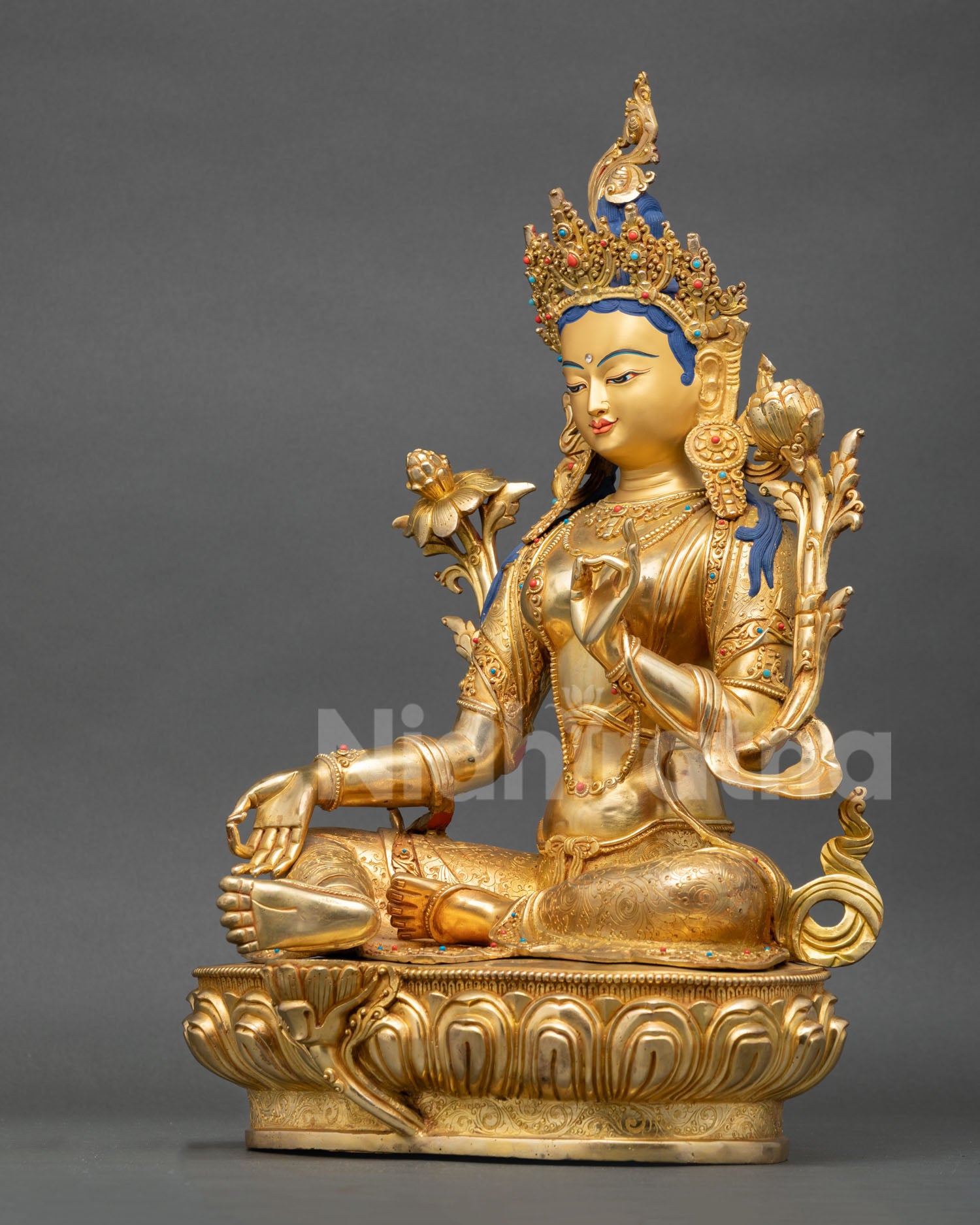 Left view of Green Tara statue showing hand-carved copper and gold-gilded details