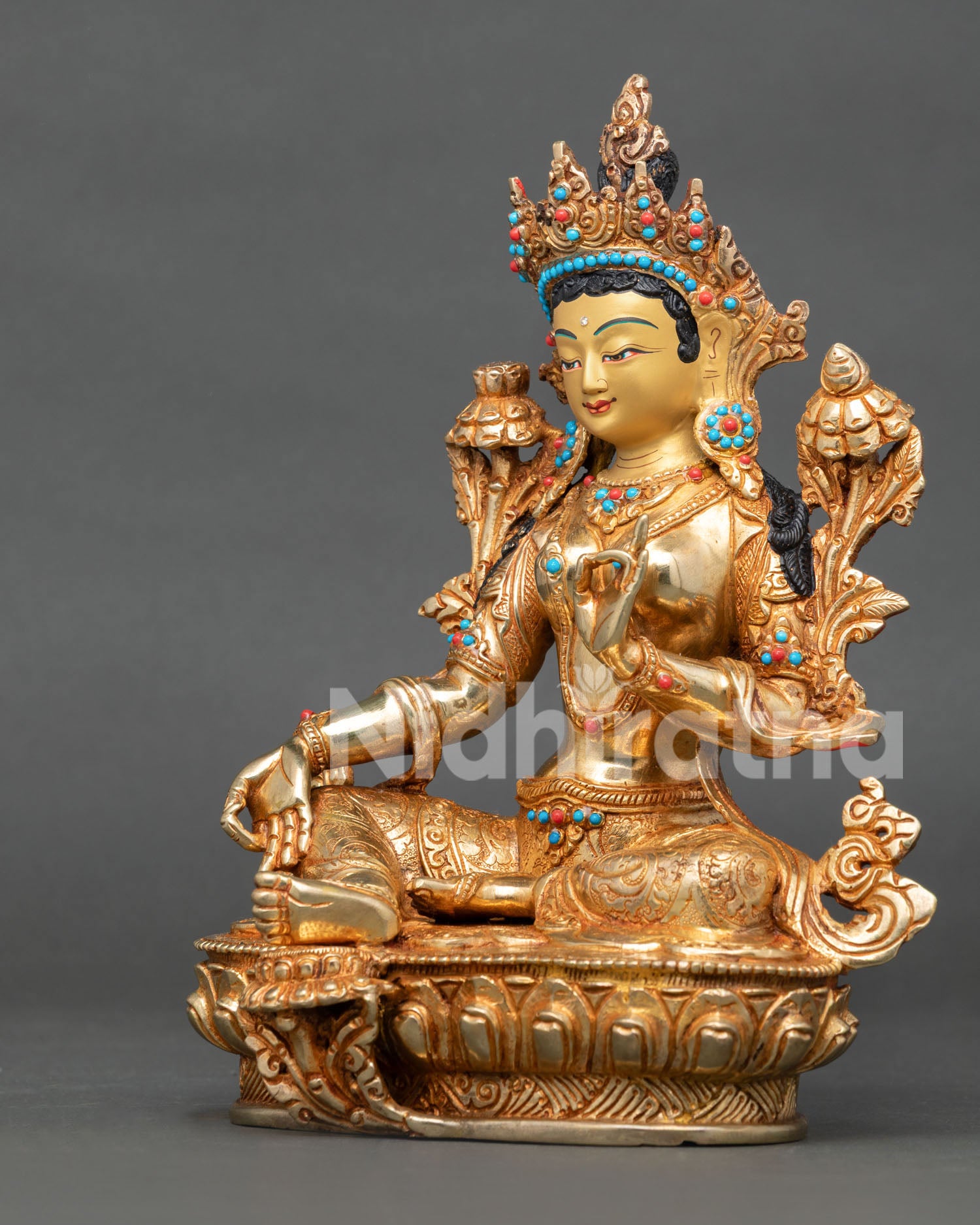 Left view of Green Tara statue with ornate fire gilded copper details