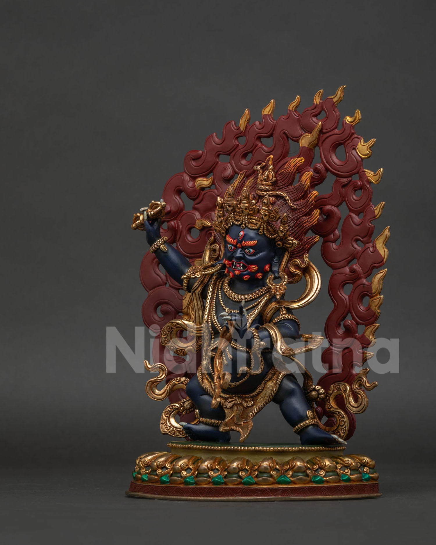 Left view of handcrafted Vajrapani protector holding a vajra and lasso on lotus pedestal.