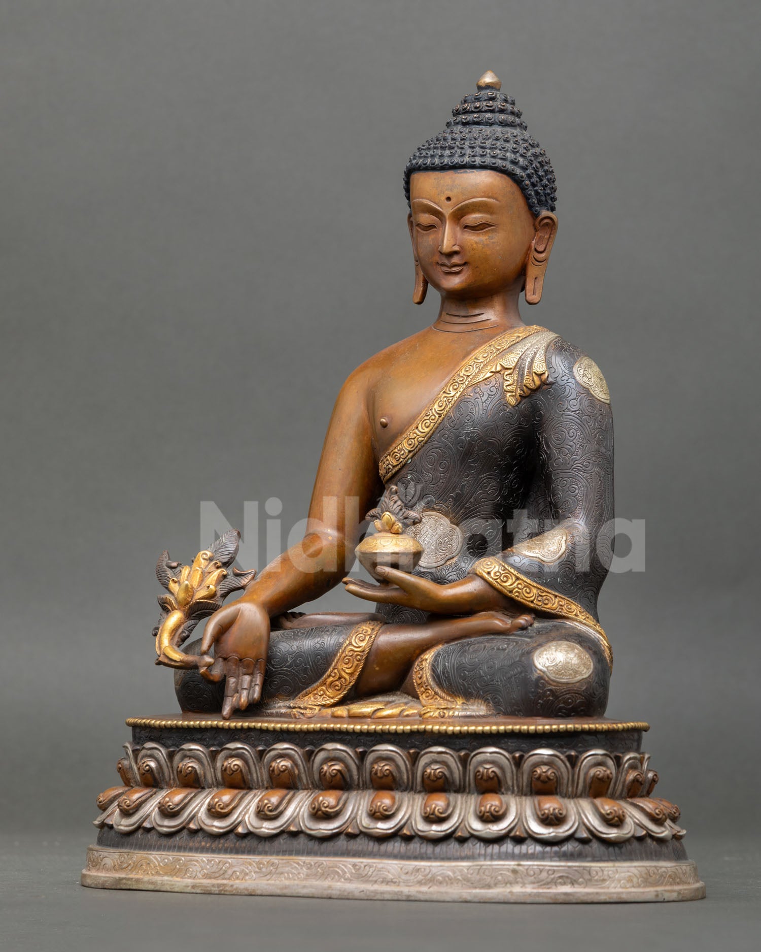 left view of healing medicine buddha statue on silver-plated lotus throne