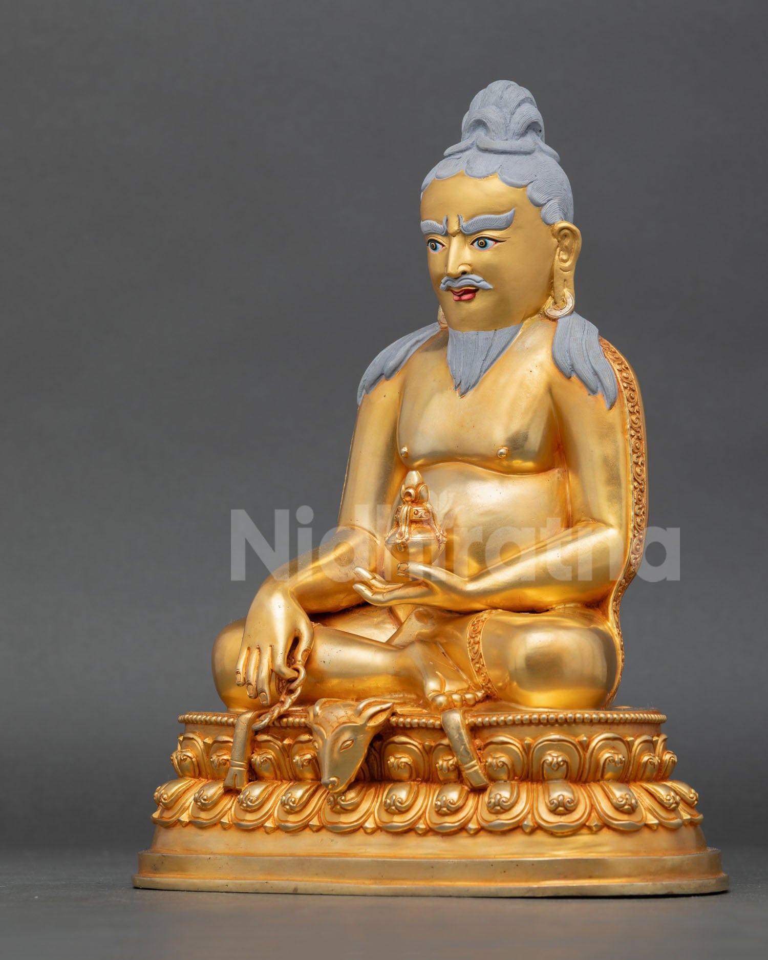 left view of thangtong gyalpo copper statue with fire gilded details