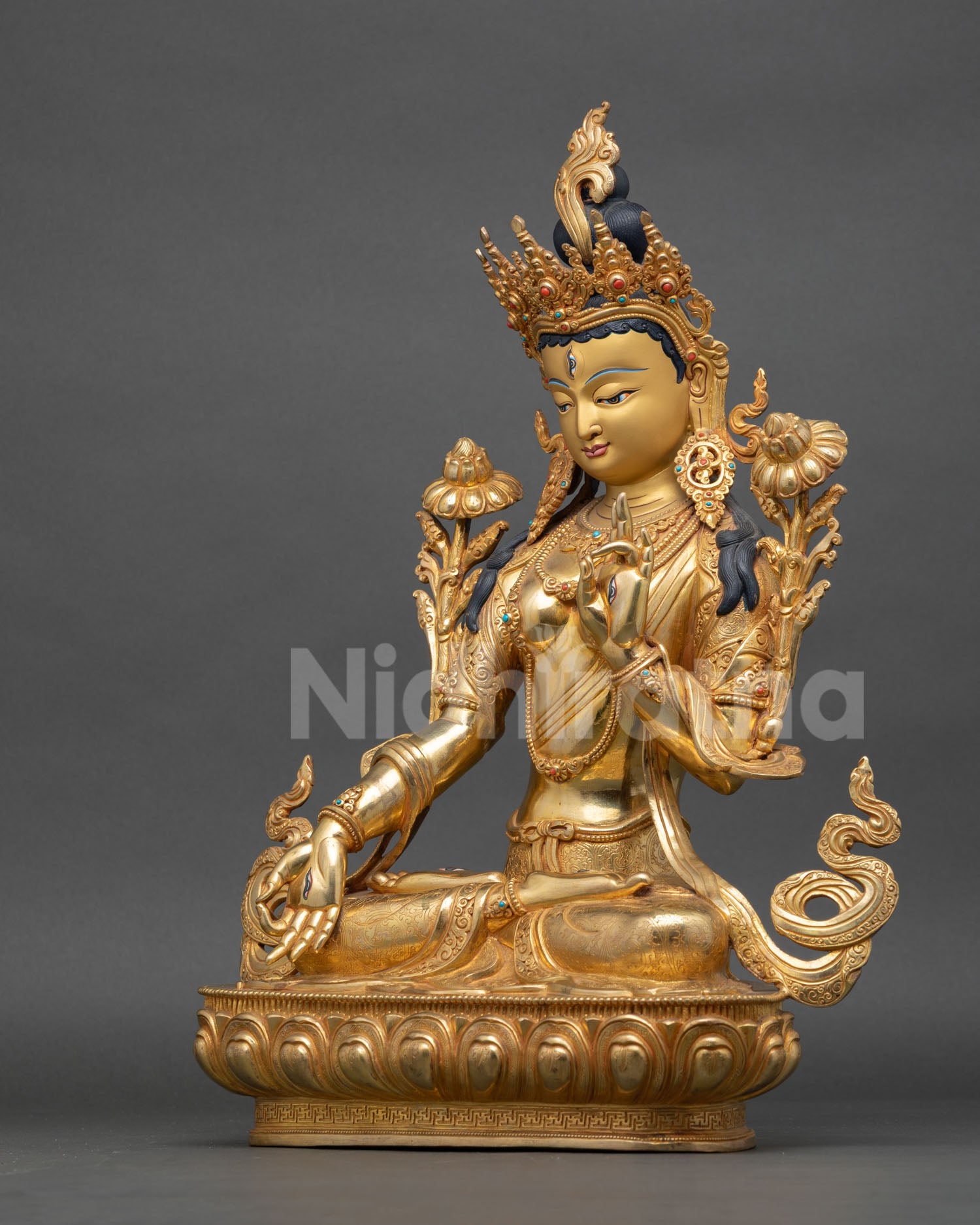 left view of white tara buddhist sculpture with acrylic detailing and sacred posture