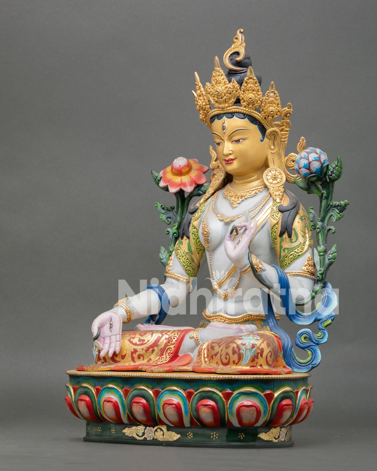 left view of white tara statue with traditional nepalese buddhist artistry