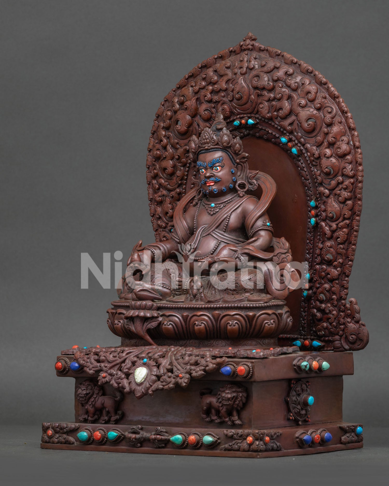 left view side of handcrafted Dzambhala statue with turquoise coral inlays and floral halo