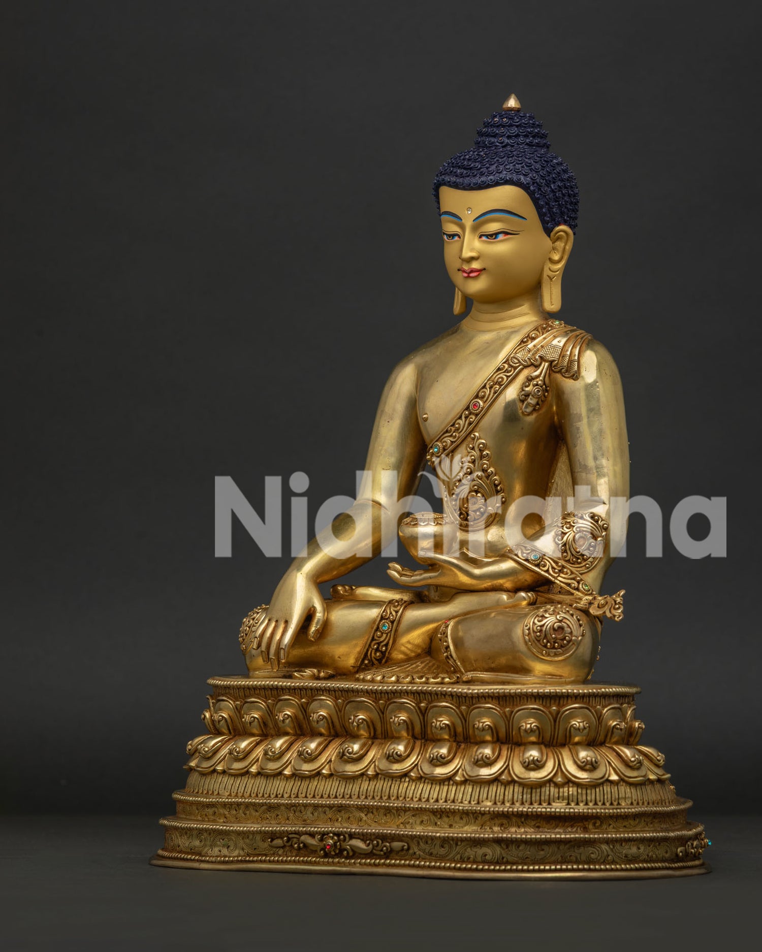 Left view side of Shakyamuni Buddha statue with copper body and traditional Buddhist details