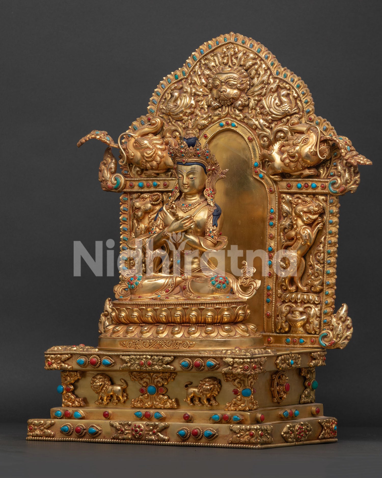 left view side of vajradhara statue with makara motifs and gemstone details