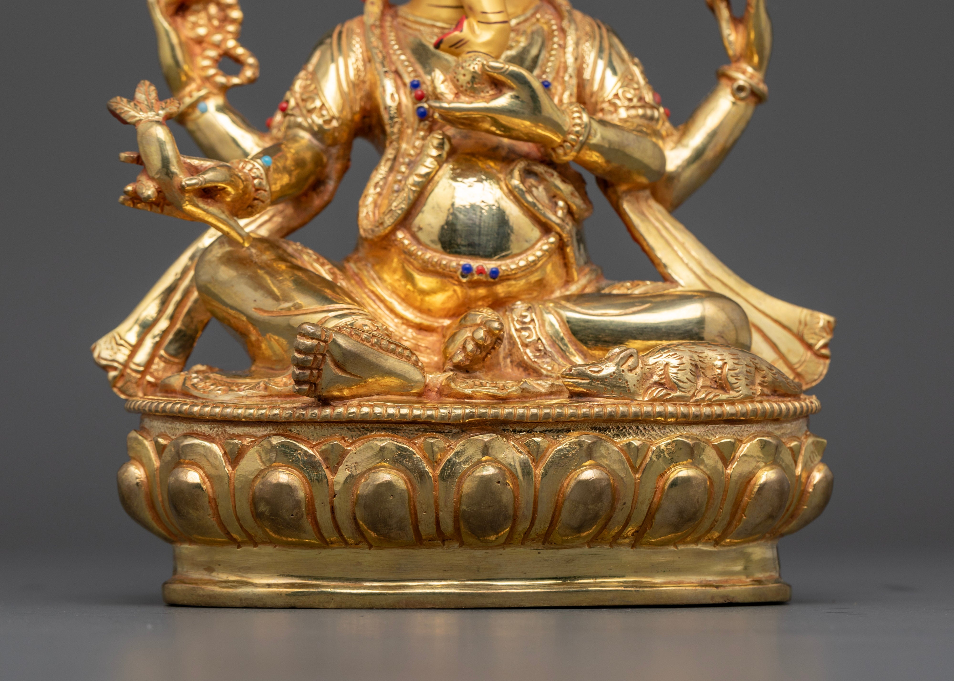 crossed leg of gold plated ganesh statue adorned with lapis lazuli and red coral