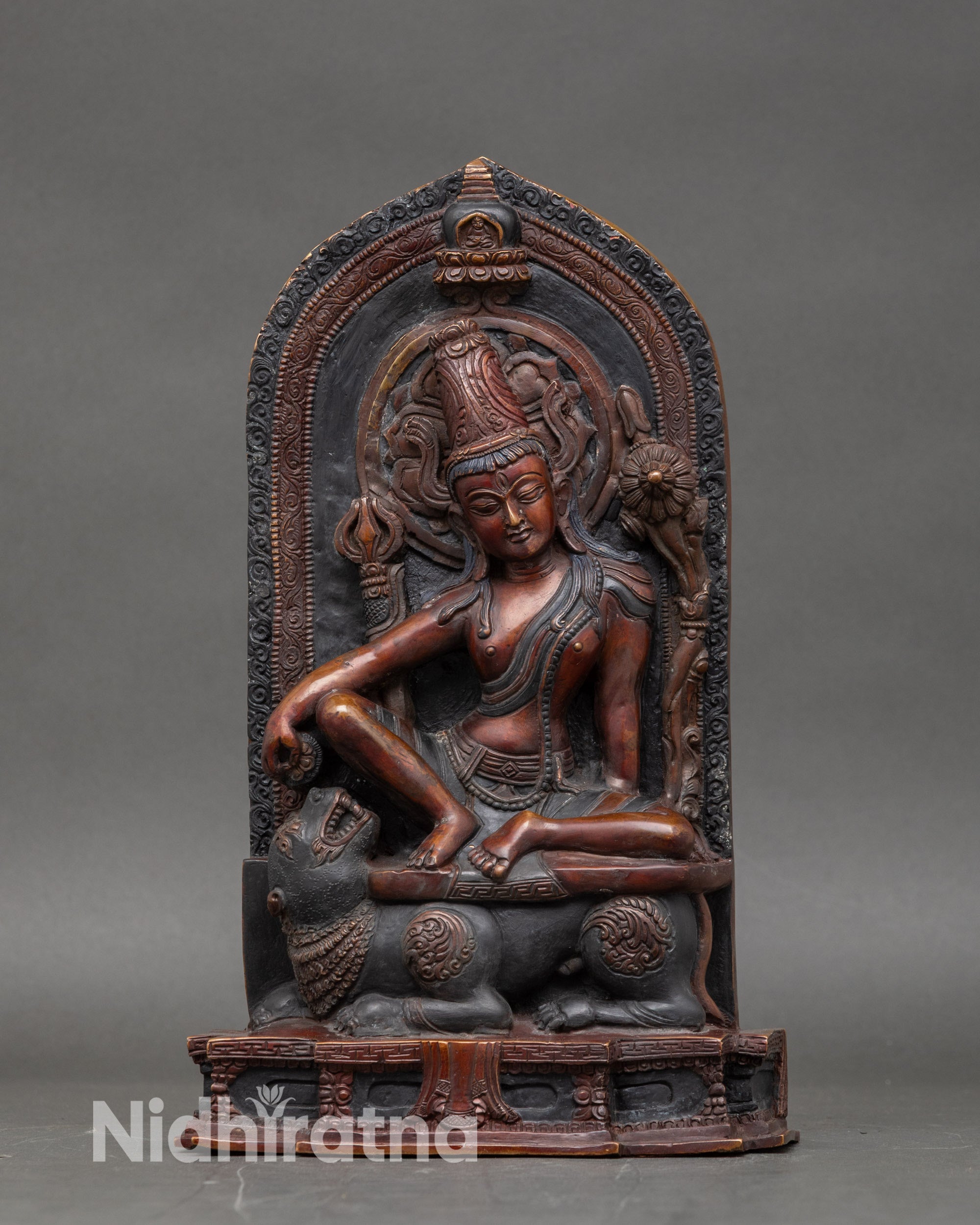 Front view of Lokeshwor statue seated on snow lion, oxidized copper with antique finish