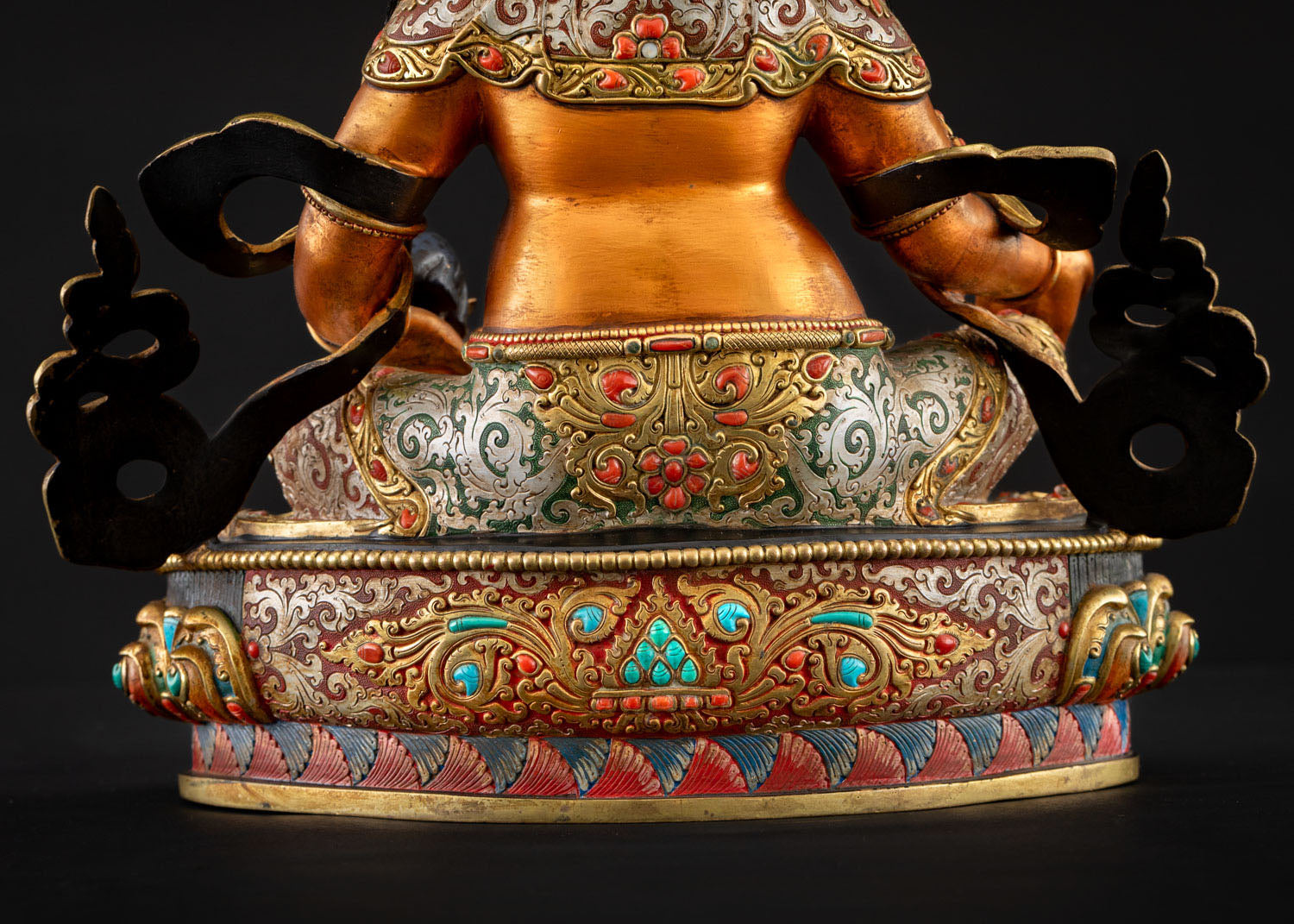Lower rear view of Yellow Dzambhala lotus pedestal and robe detail