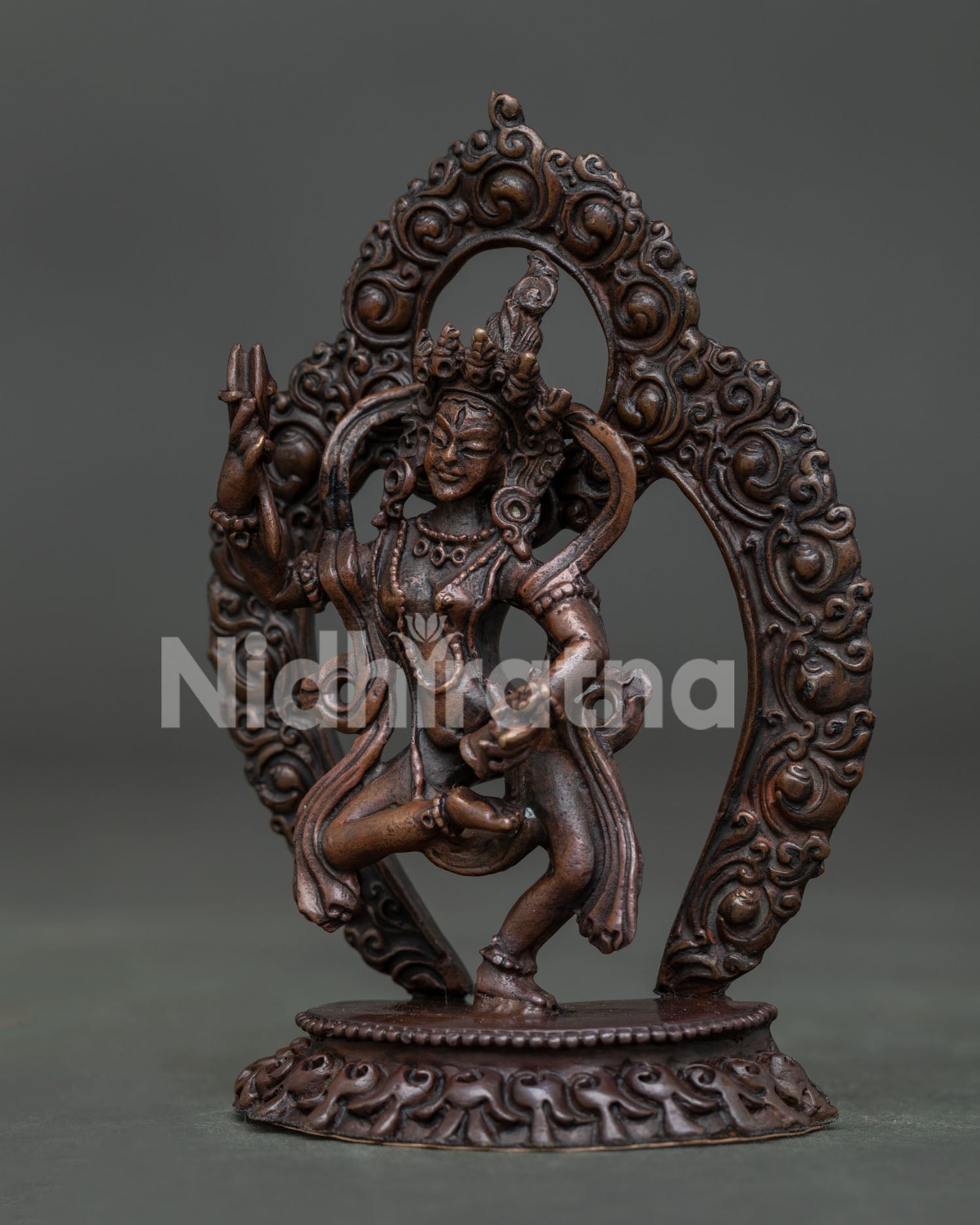 Machig Labdron statue side view holding ritual bell and damaru in dancing posture.