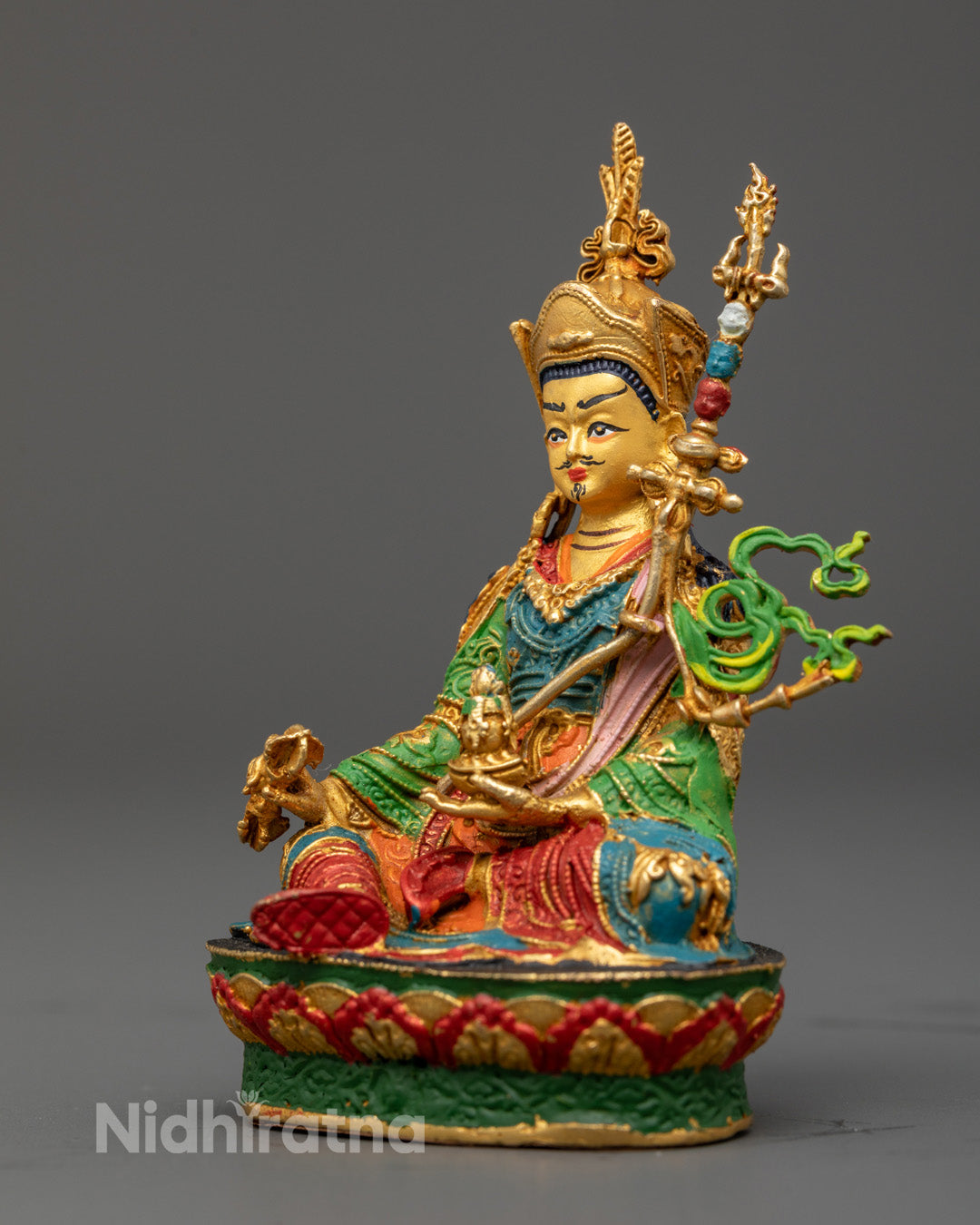 machine-made Padmasambhava sculpture seated on a multi-colored lotus base – vibrant Buddhist altar statue for home or temple