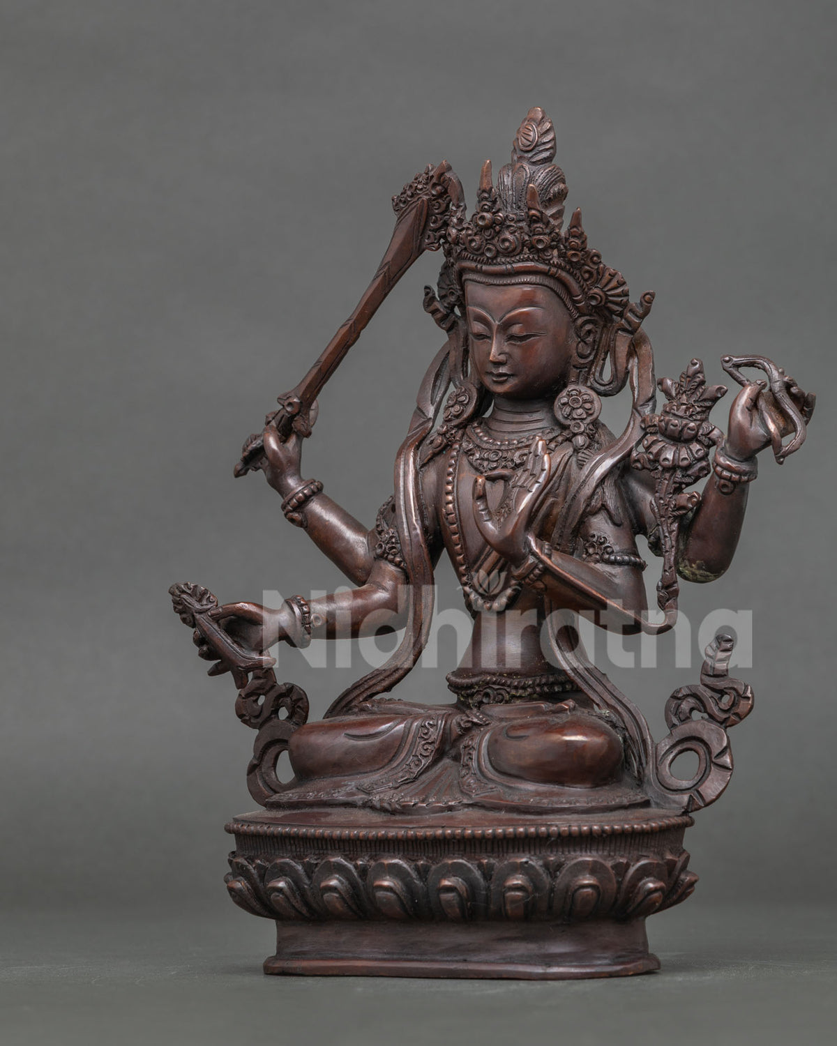 Maha Manjushri statue bow arrow five jewel crown detailed view.