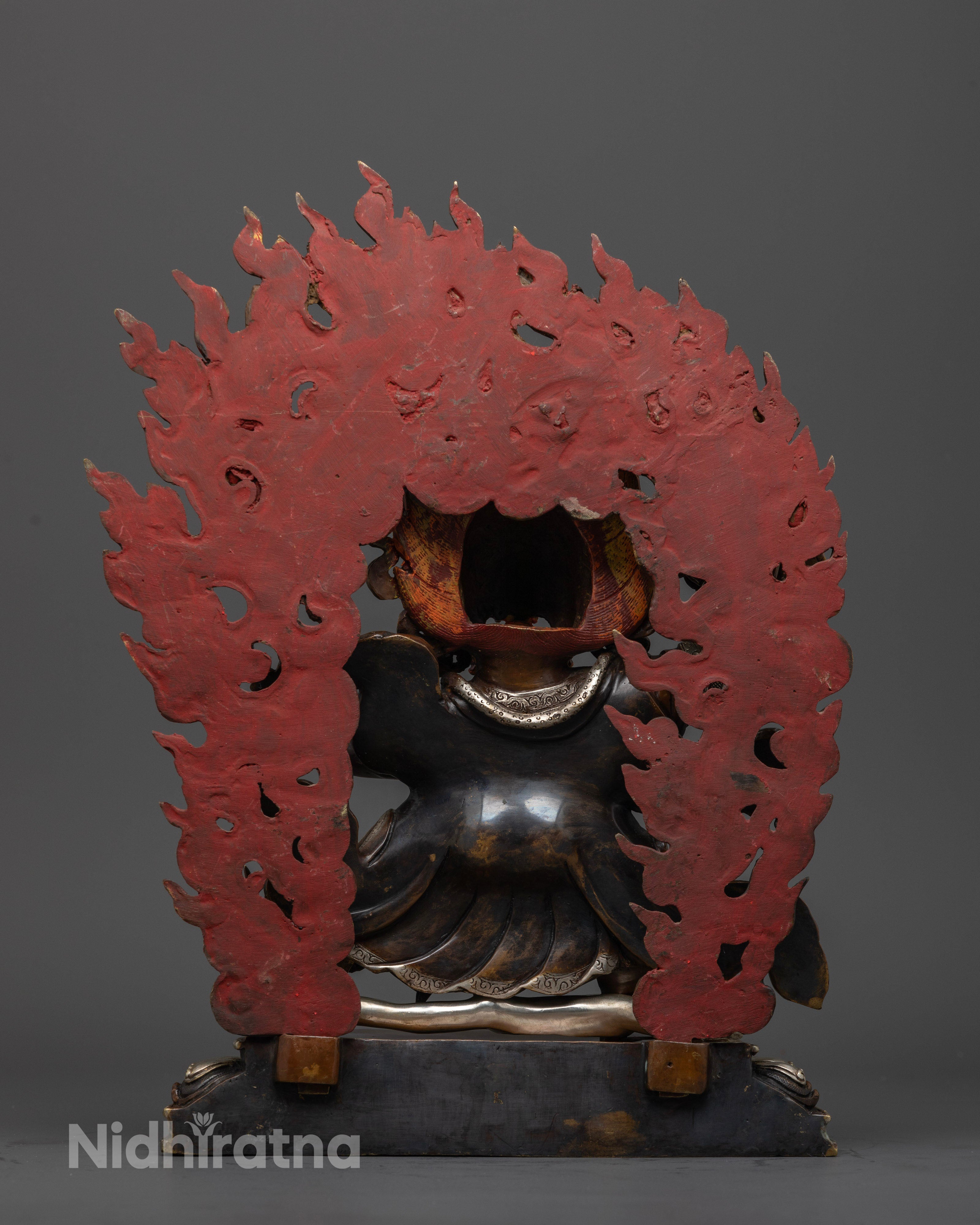 back view of mahakala bernagchen statue with the flames colored red color