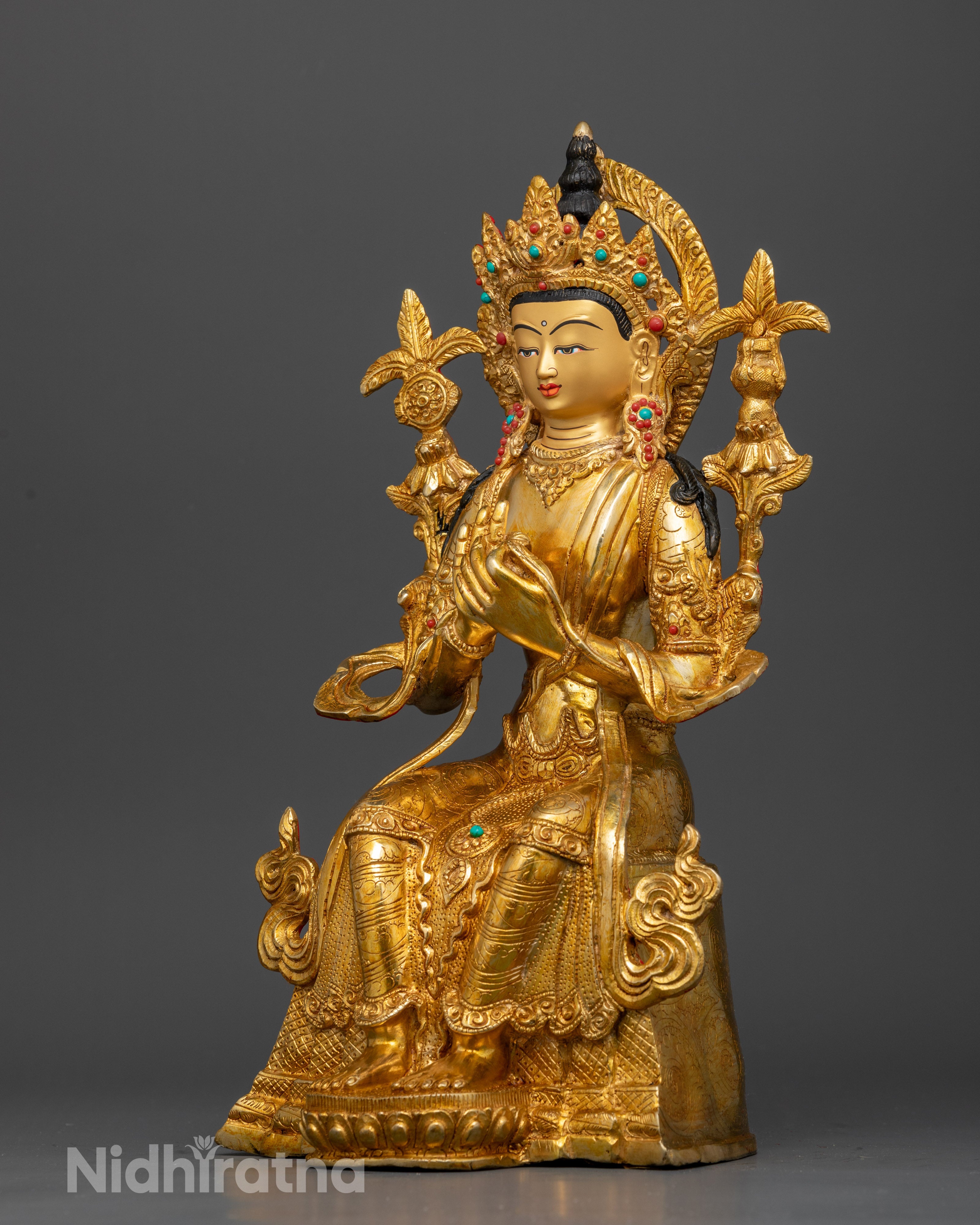 Maitreya Buddha sculpture featuring intricate jewelry, semi-precious stones, and gold fire gilding
