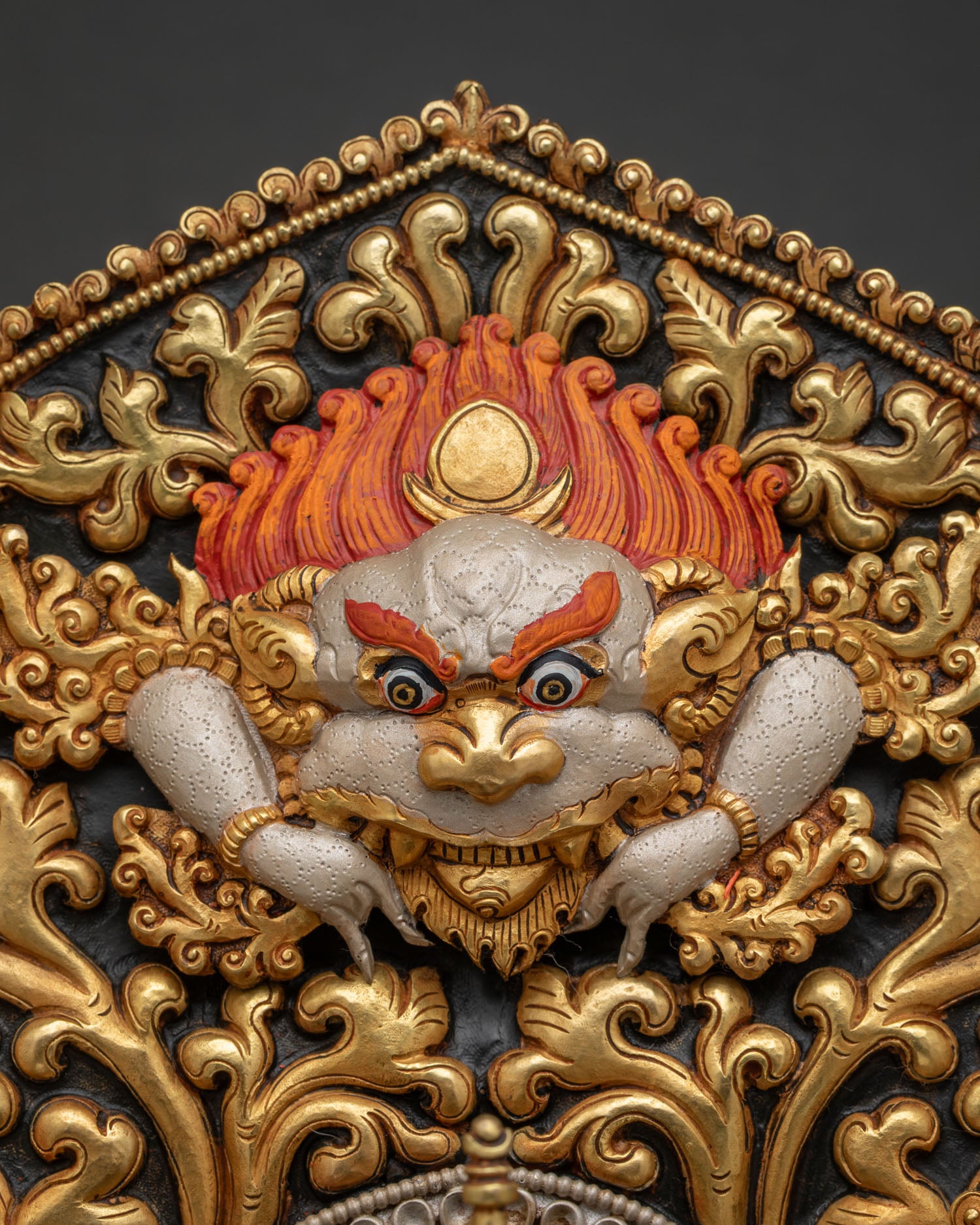 Maitreya Buddha statue upper halo close-up with fierce kirtimukha detail