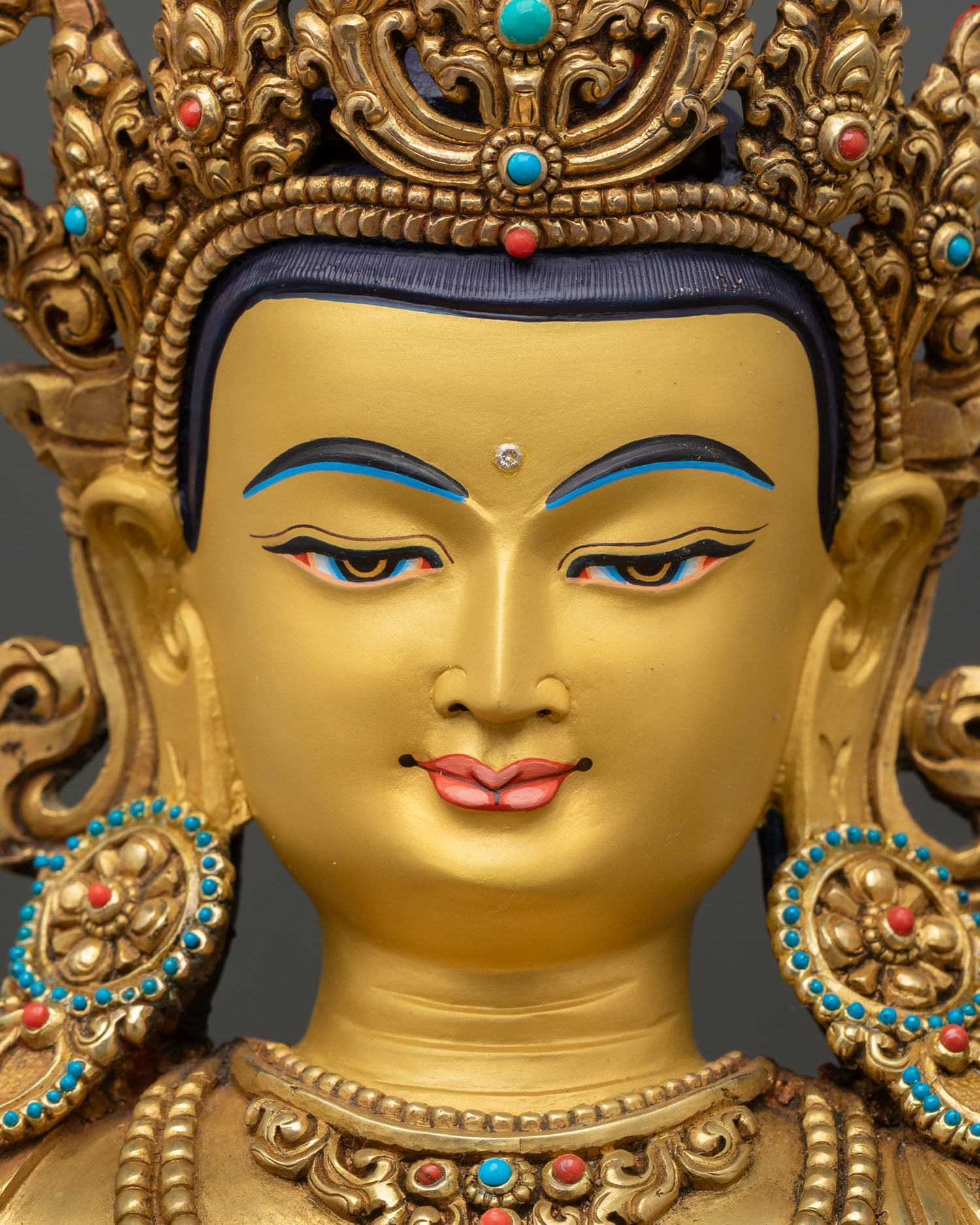 Manjushri Bodhisattva statue showing detailed gold painted face semi precious stone inlay and fine Newari artisan Himalayan craftsmanship