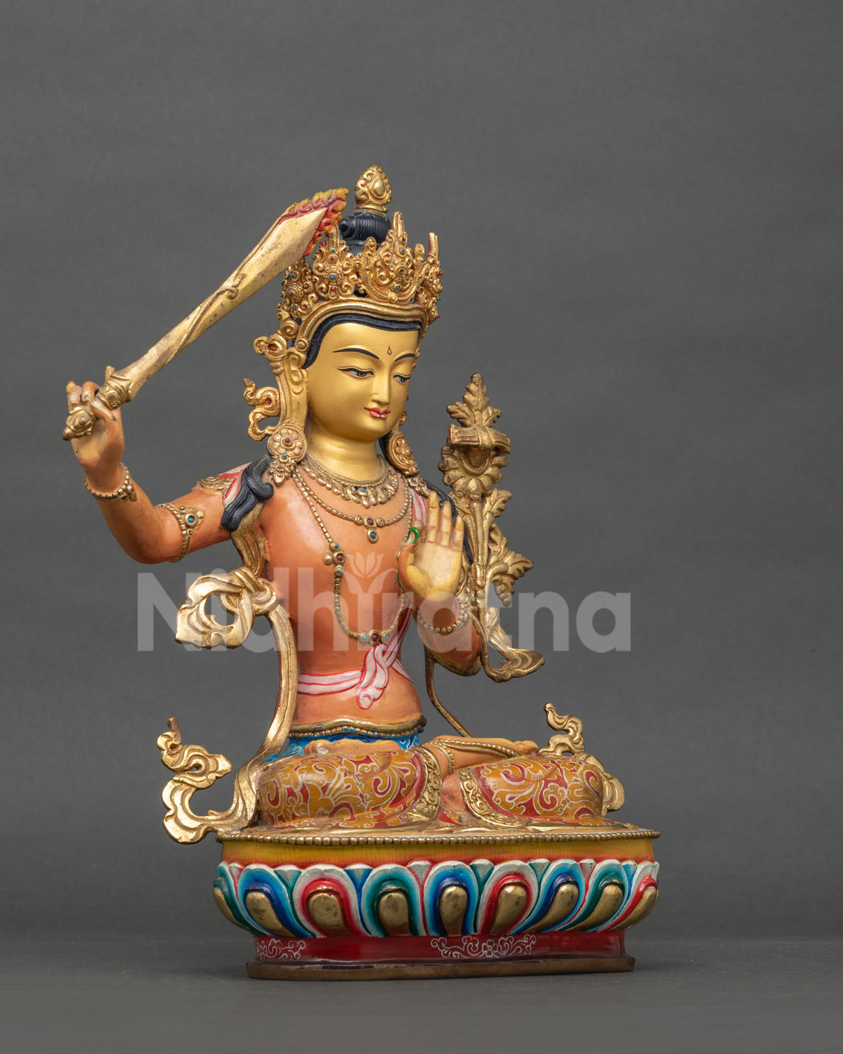 Manjushri Buddha statue holding flaming sword of wisdom and Prajnaparamita Sutra.