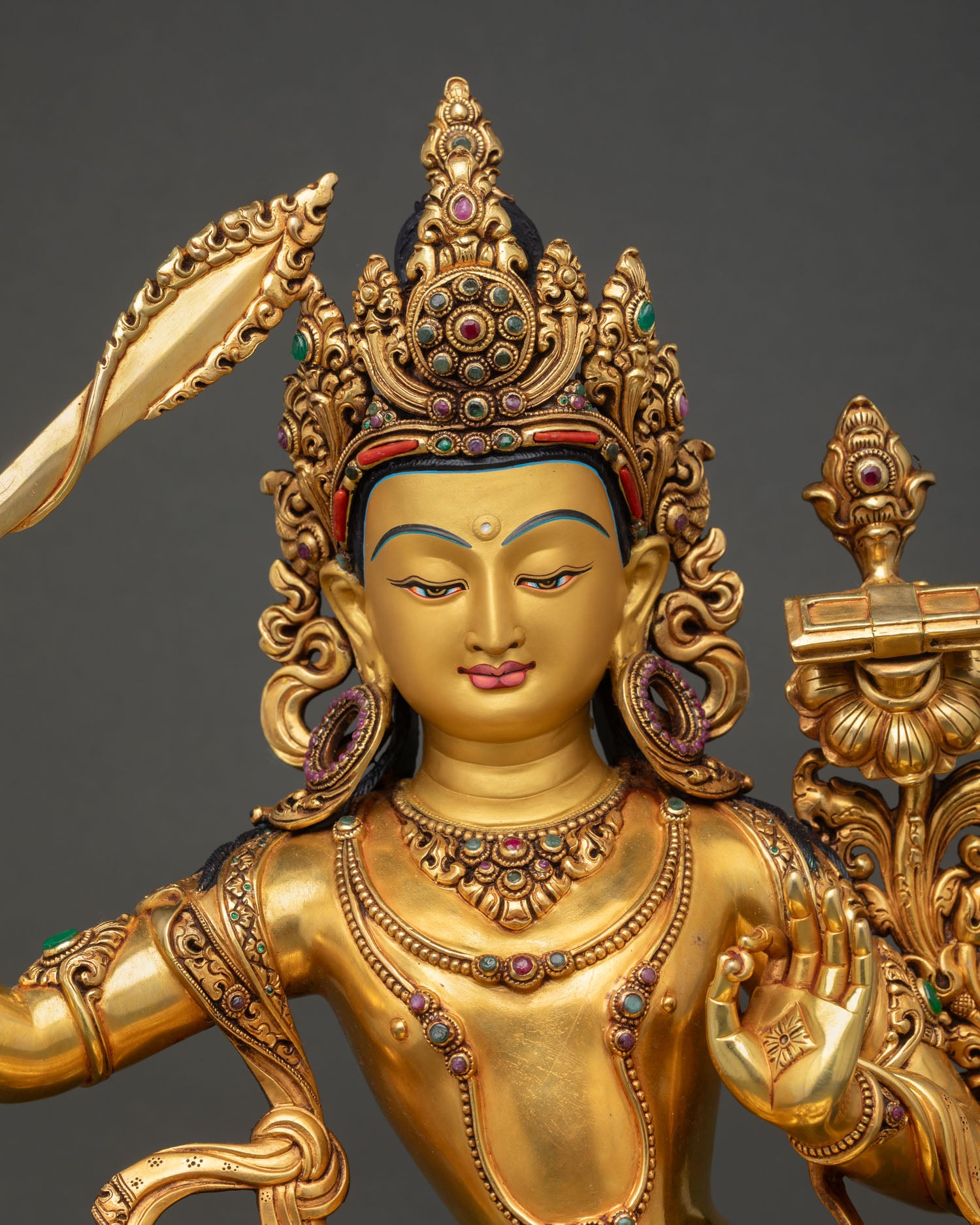 Regular close up: Manjushri Buddhist statue Nepal detail view 24K gold gilding turquoise coral crown