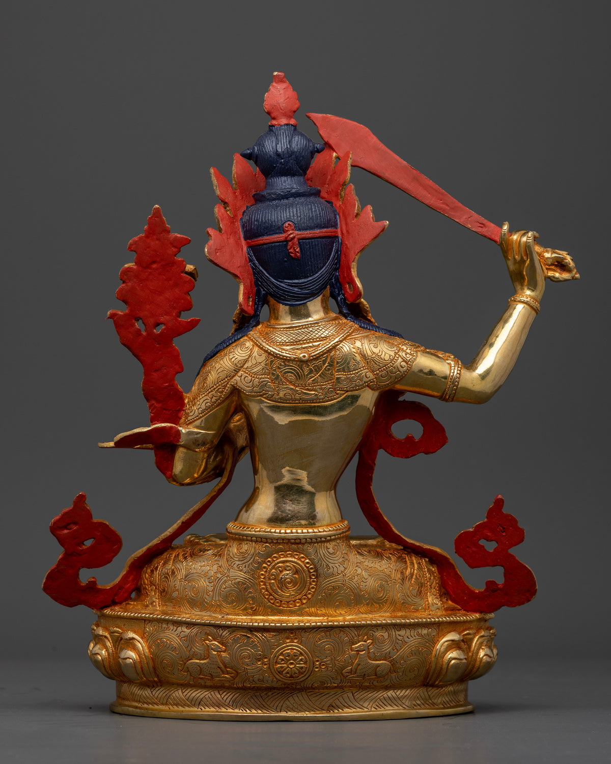 Manjushri Statue back view floral garment double lotus pedestal.