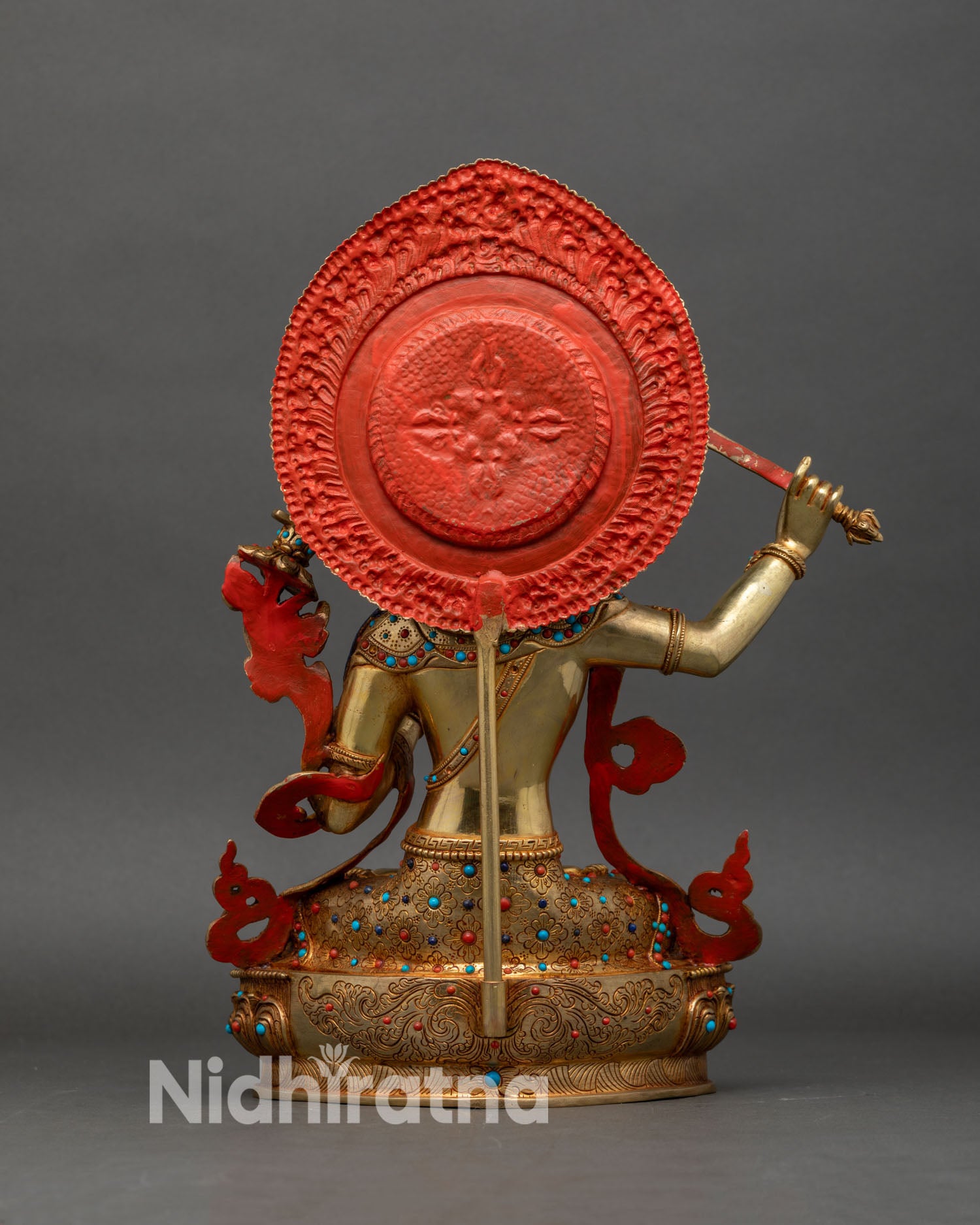 back view of manjushri statue showing detailed halo, robe engravings and handcrafted nepali metalwork