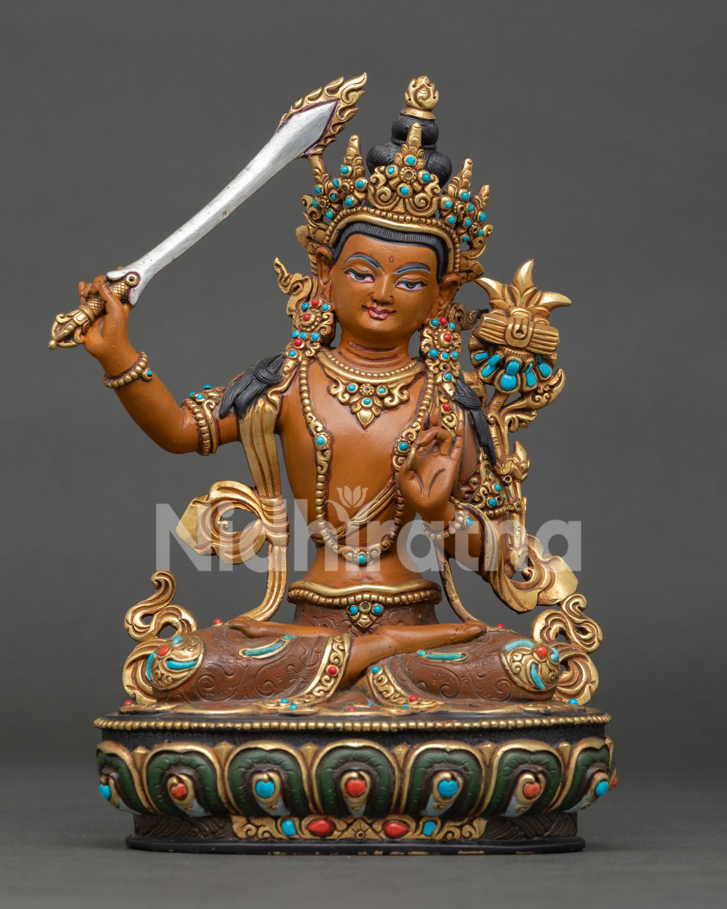 Manjushri statue representing transcendent wisdom, holding the flaming sword that cuts through ignorance.