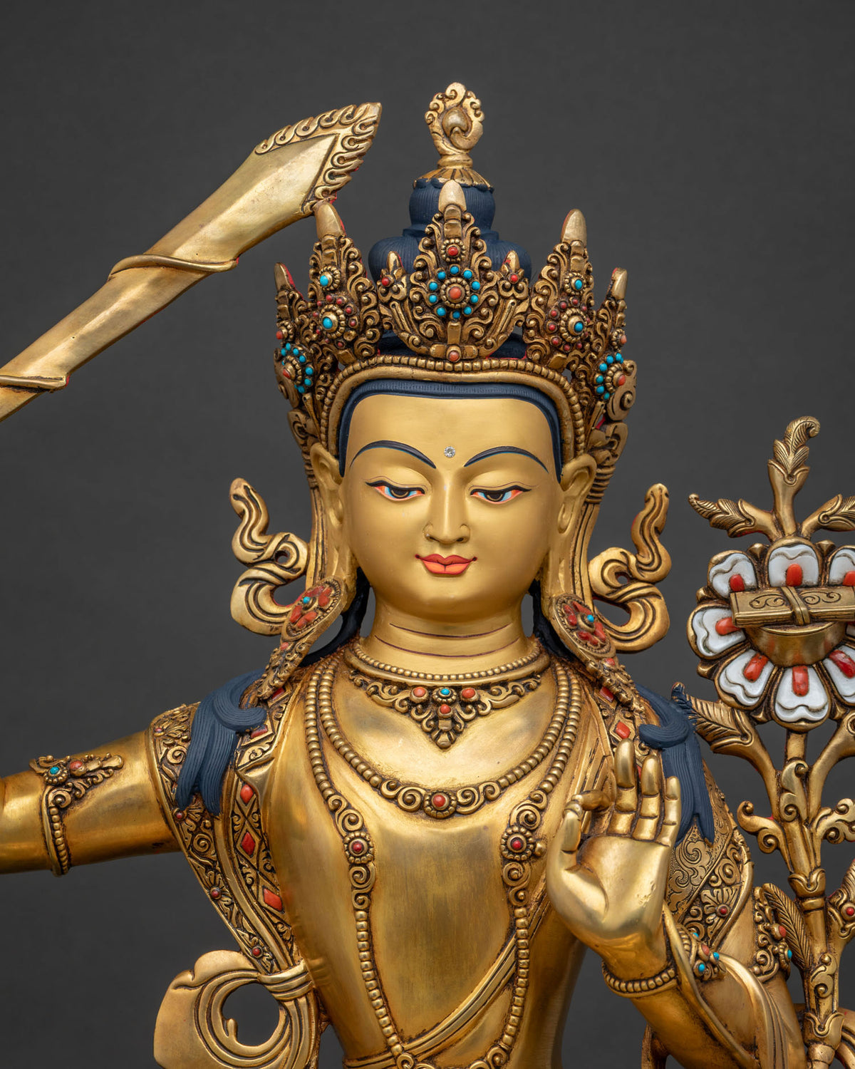 Manjushri Statue close-up of gold-gilded robe, jewelry and hand mudra detail