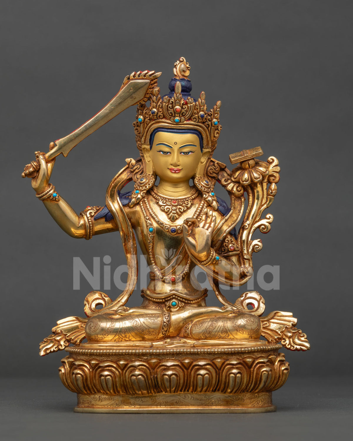 Manjushri statue copper gold fire gilded 24k gold face Patan Nepal.