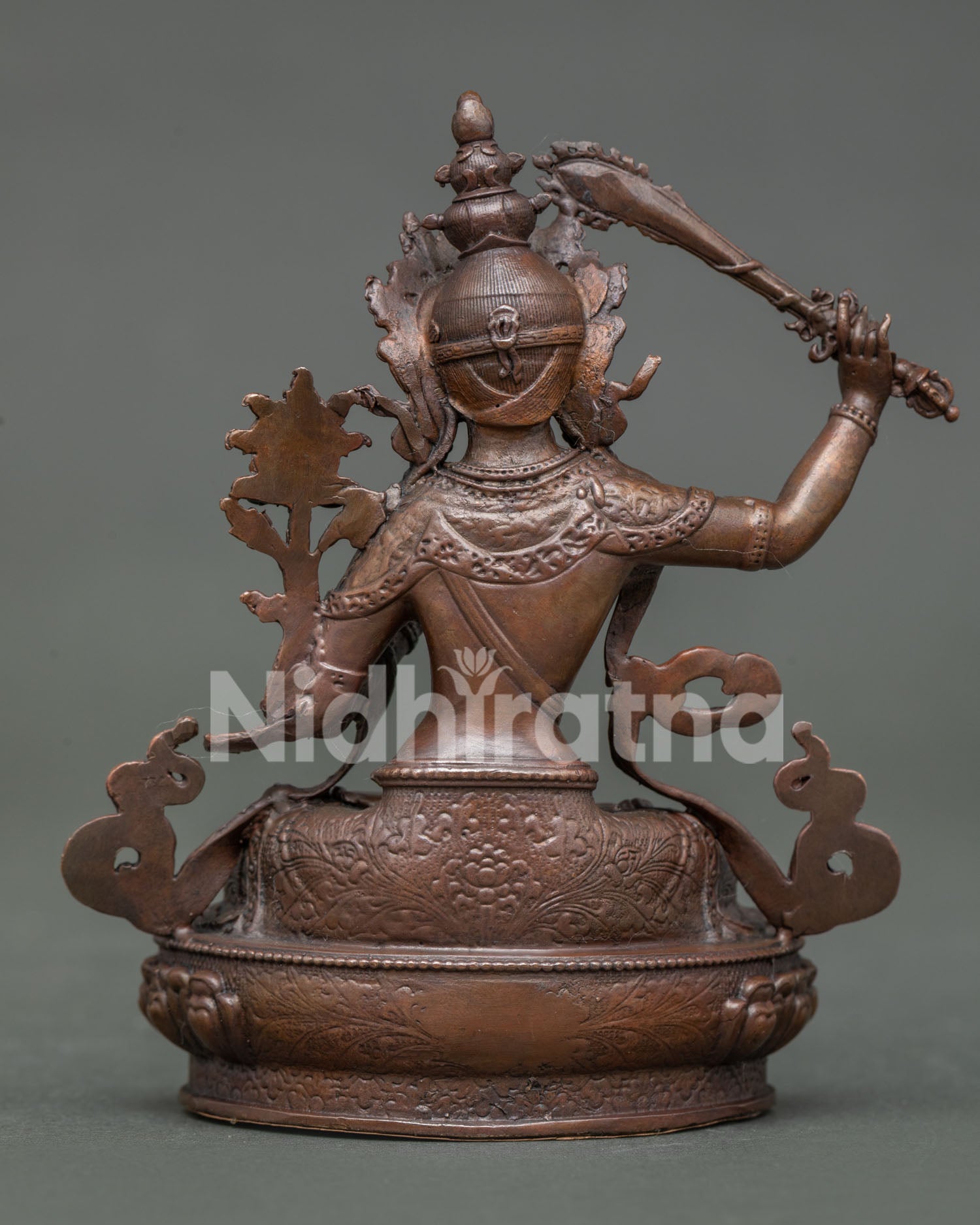 Manjushri statue displaying detailed copper artwork and himalayan buddhist design.