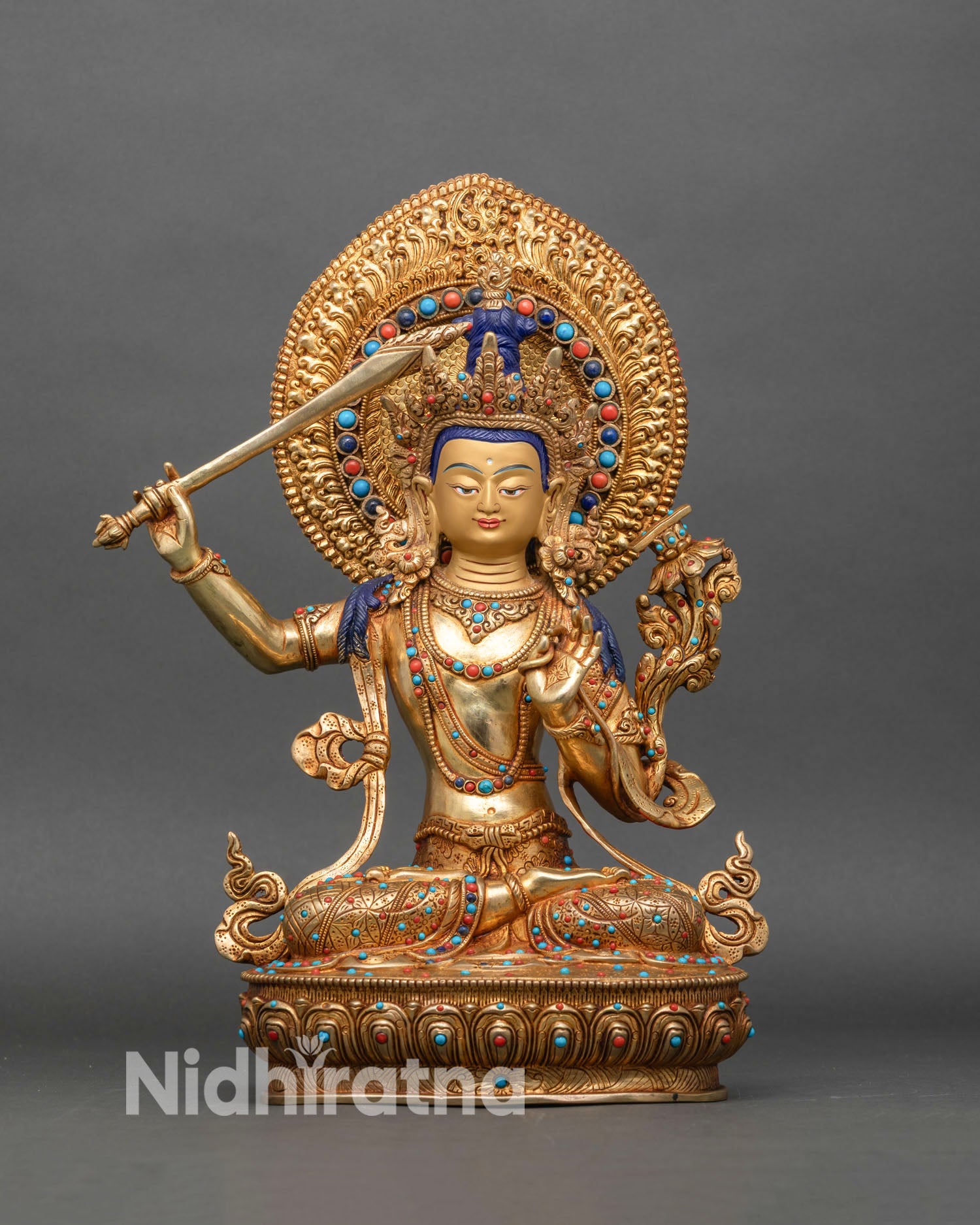 manjushri statue front view, fire gilded gold copper bodhisattva on lotus with sword and utpala