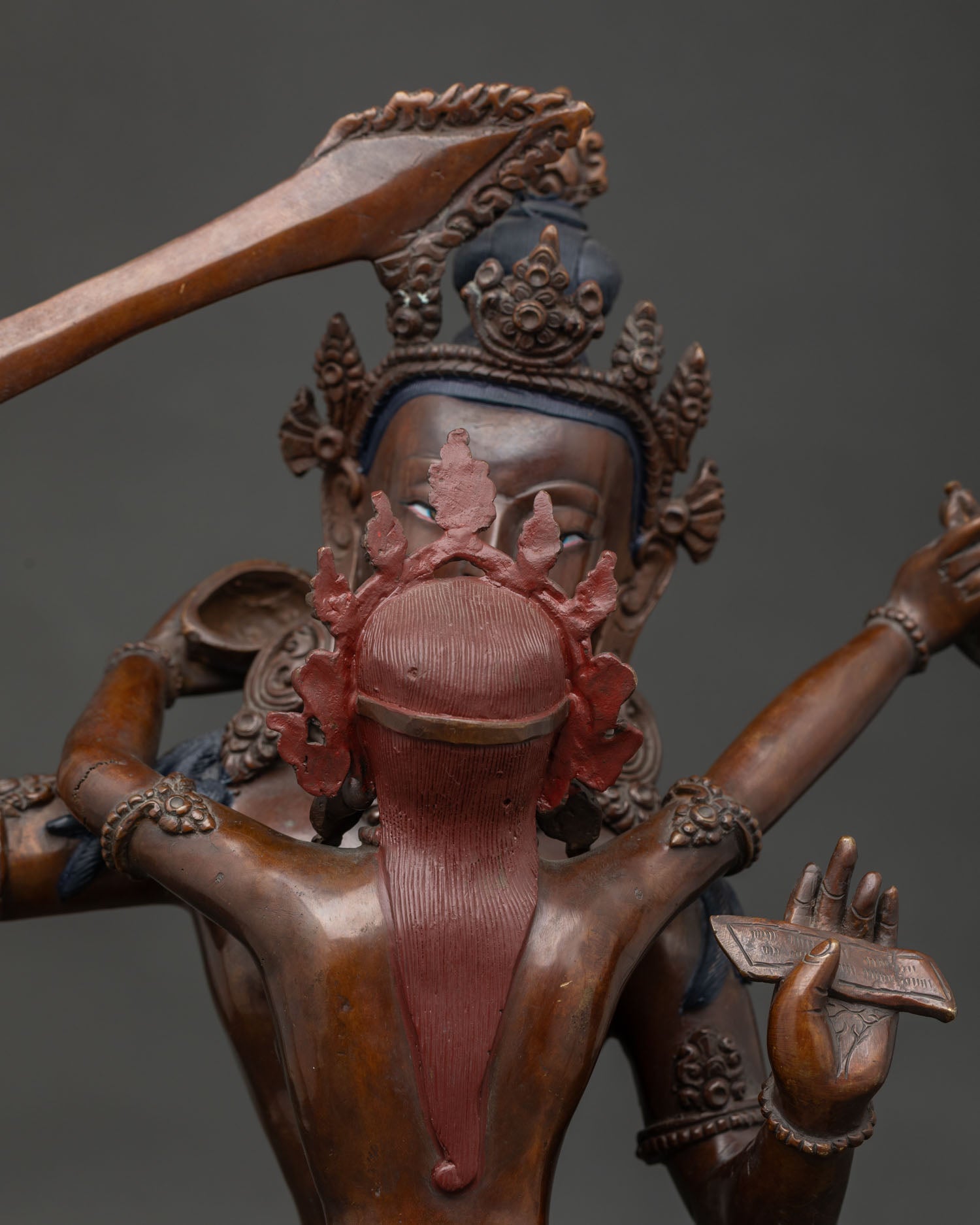 Manjushri statue holding flaming wisdom sword and Prajnaparamita Sutra.