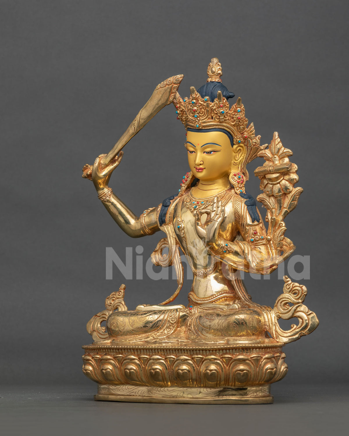 Manjushri statue holding Prajnaparamita Sutra with five jewel crown.