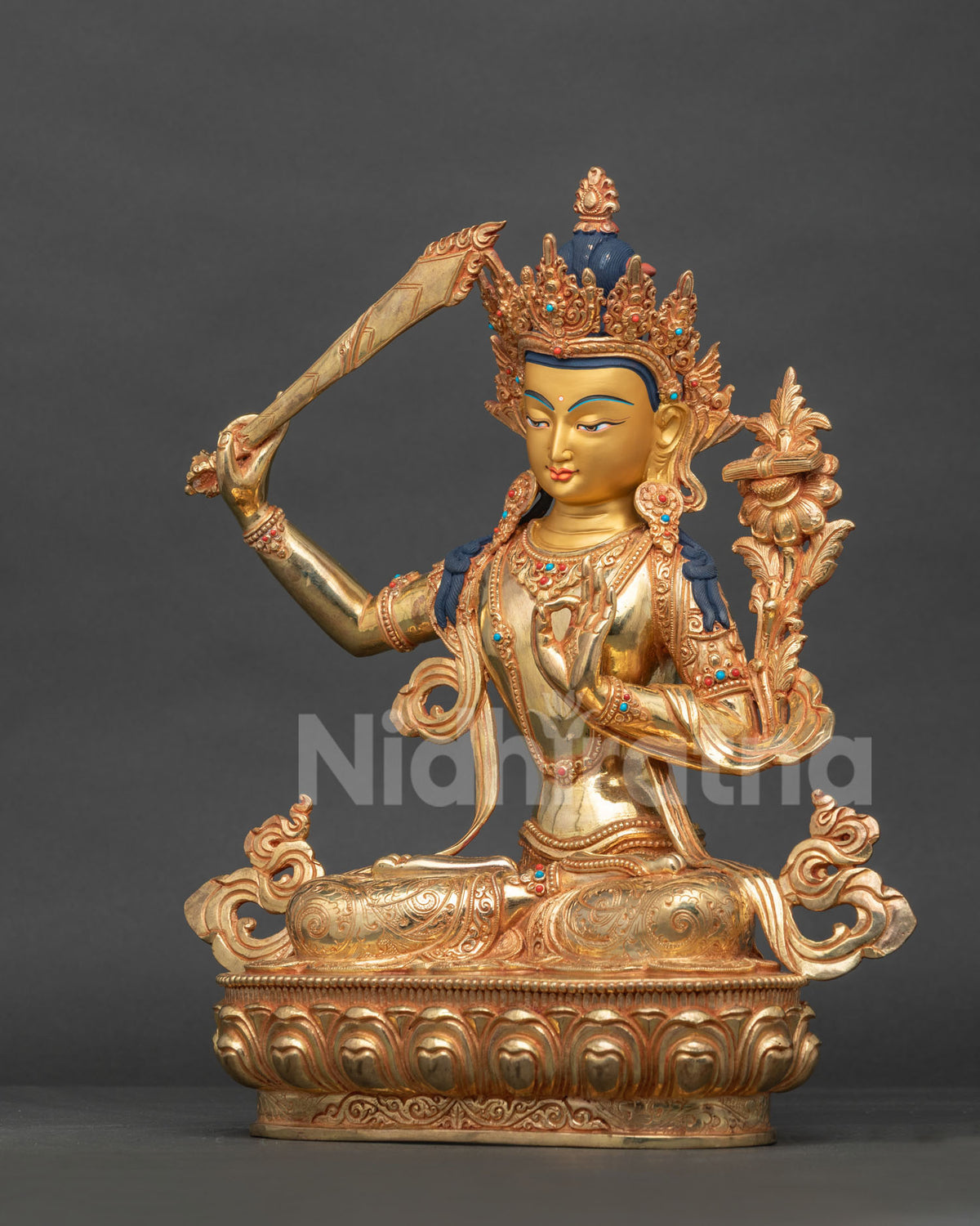 Manjushri statue on hand carved lotus pedestal with five jewel crown and layered necklaces.