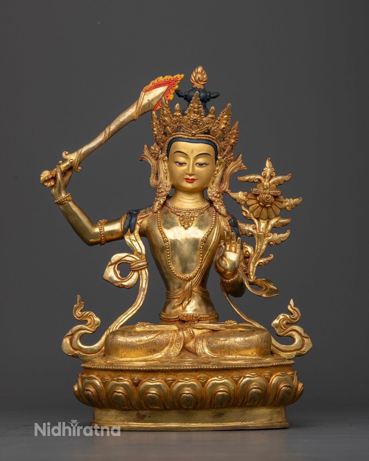 Manjushri Statue raising sword of wisdom and holding Prajnaparamita Sutra.